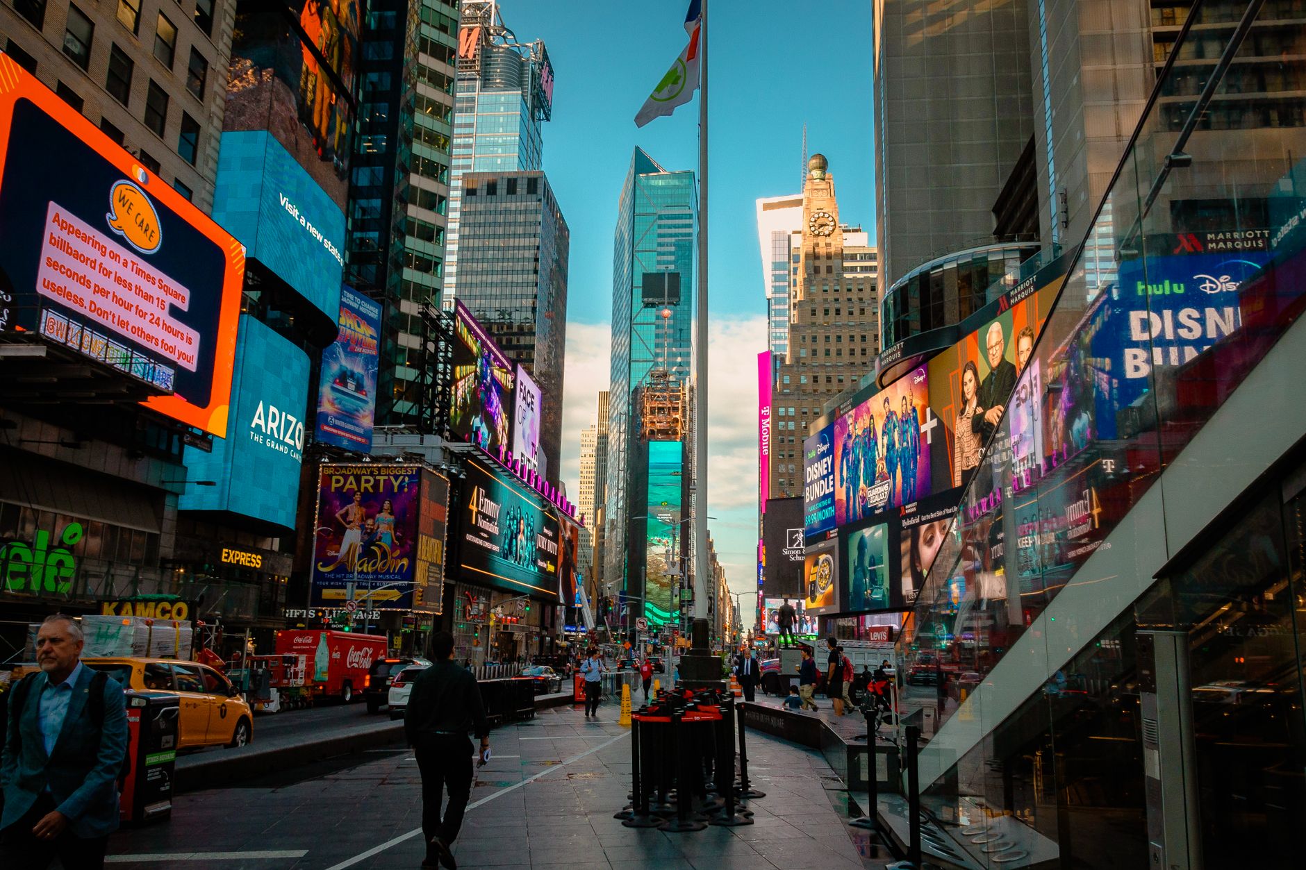 Colorful street view of Times Square with busy city life and iconic billboards in New York City.