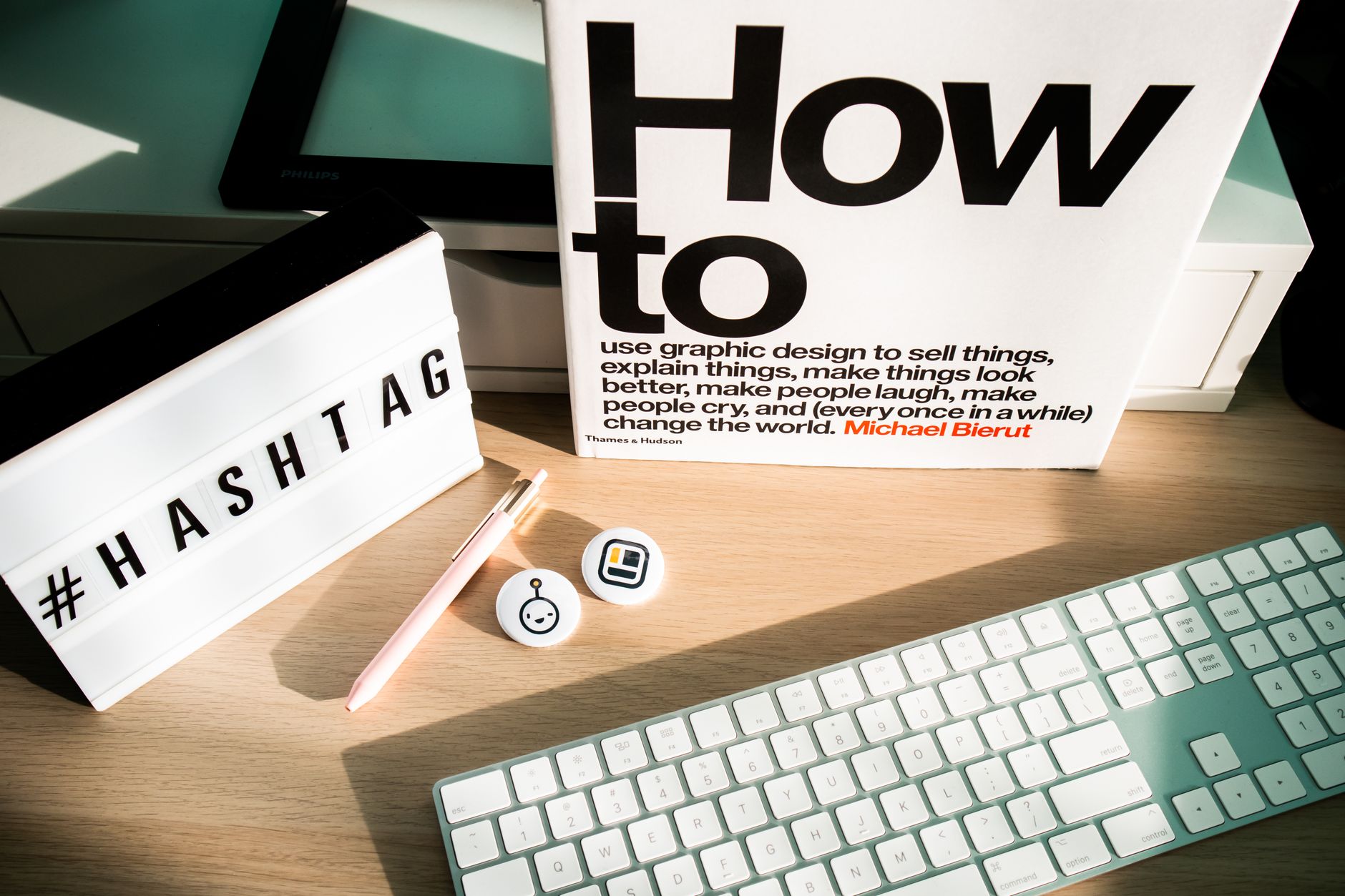 Contemporary workspace featuring a keyboard, book, and light box, ideal for tech and design themes.