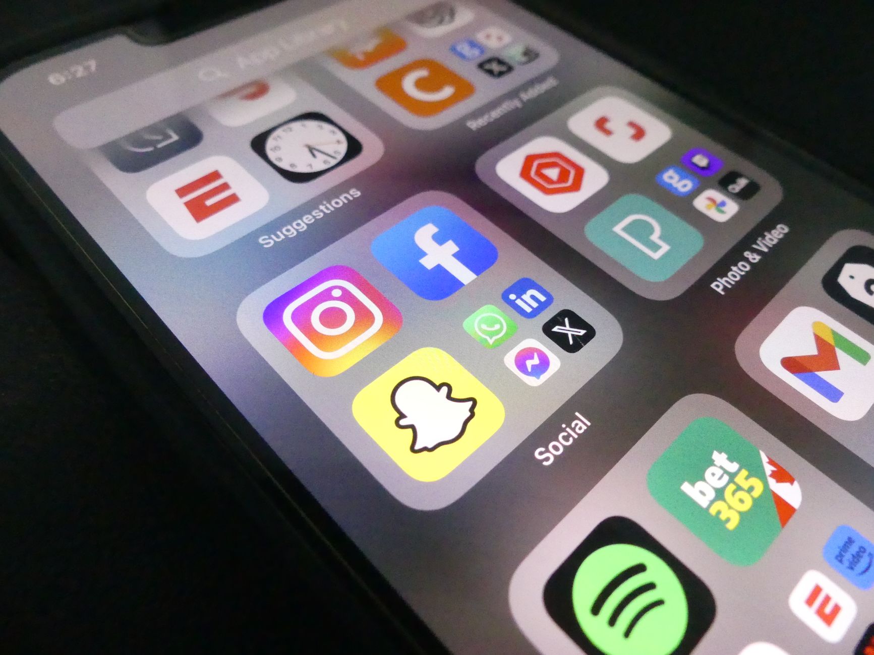 Close-up view of a smartphone screen featuring popular social media application icons.