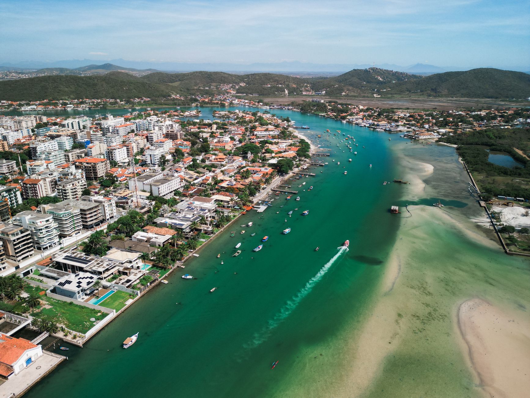 Stunning aerial shot capturing a coastal city's vibrant waterways, architecture, and scenic landscape.