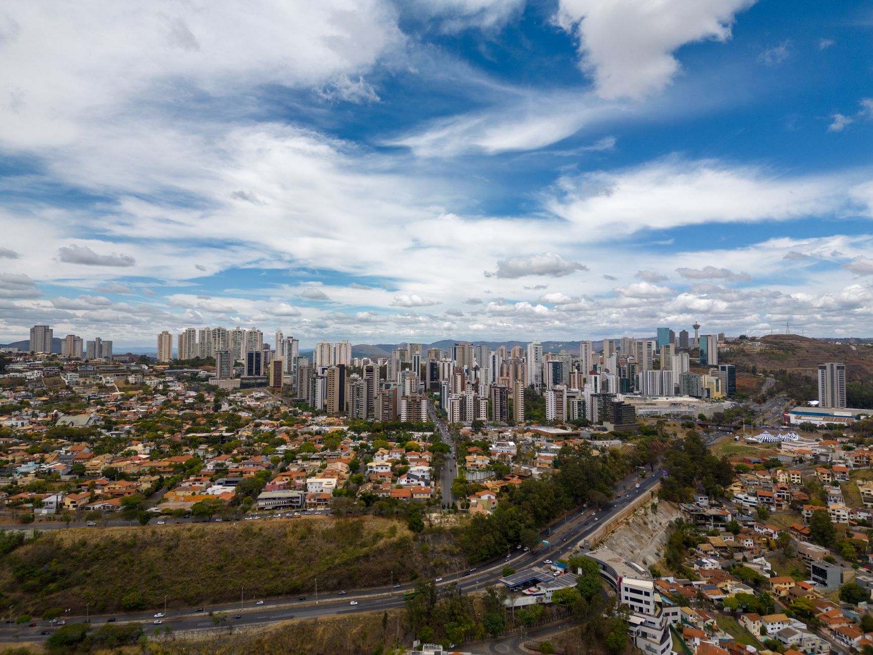 Aerial photograph showcasing the stunning skyline of Belo Horizonte, Brazil under a vibrant blue sky.