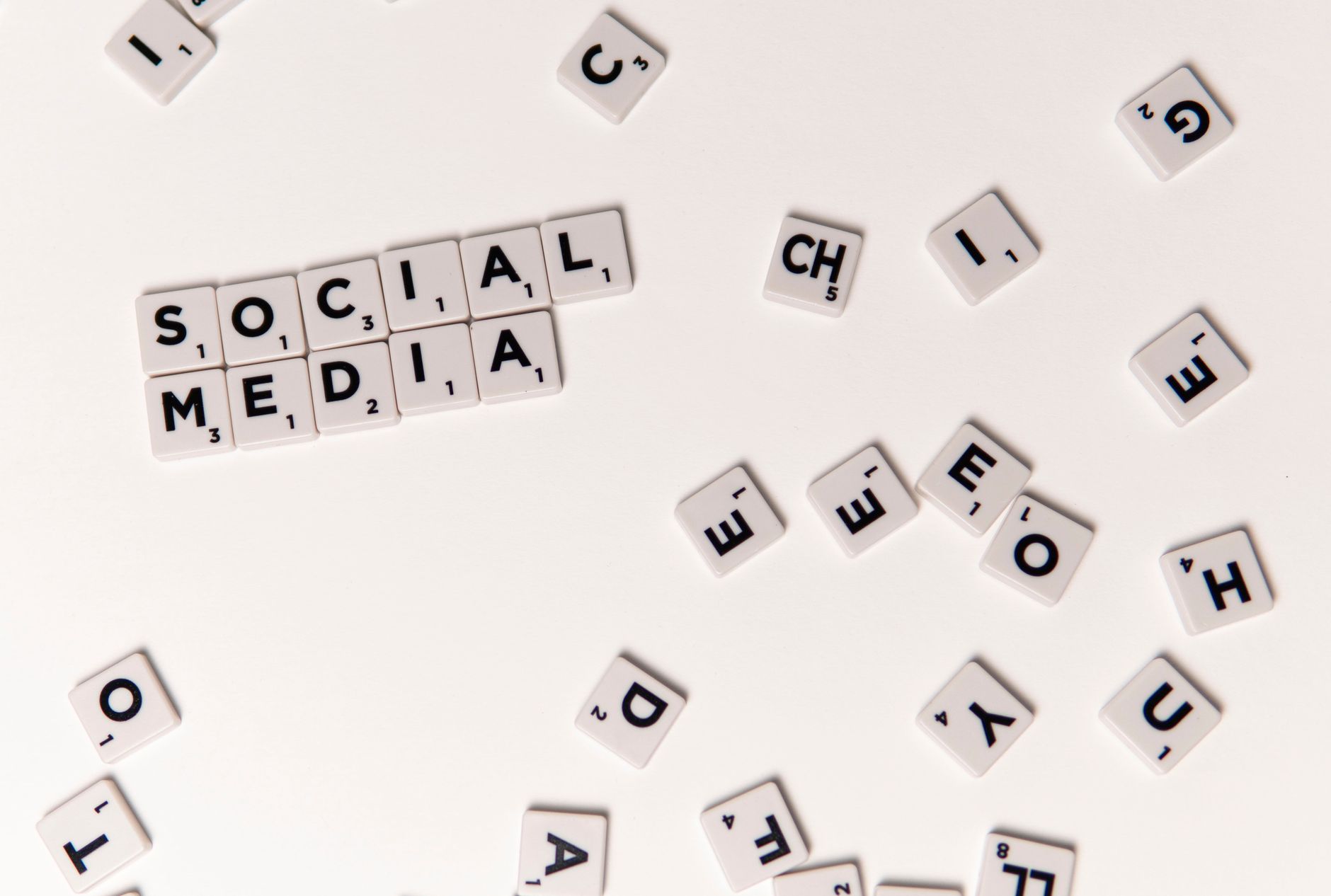 Scrabble tiles spelling 'Social Media' on a white background, symbolizing digital communication.