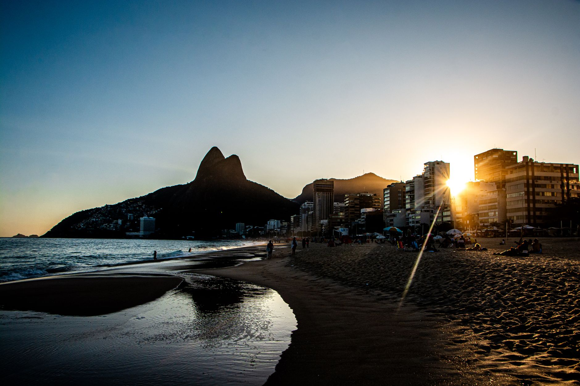 Stunning sunset view at Ipanema Beach, Rio de Janeiro with Dois Irmãos Mountain in the background.