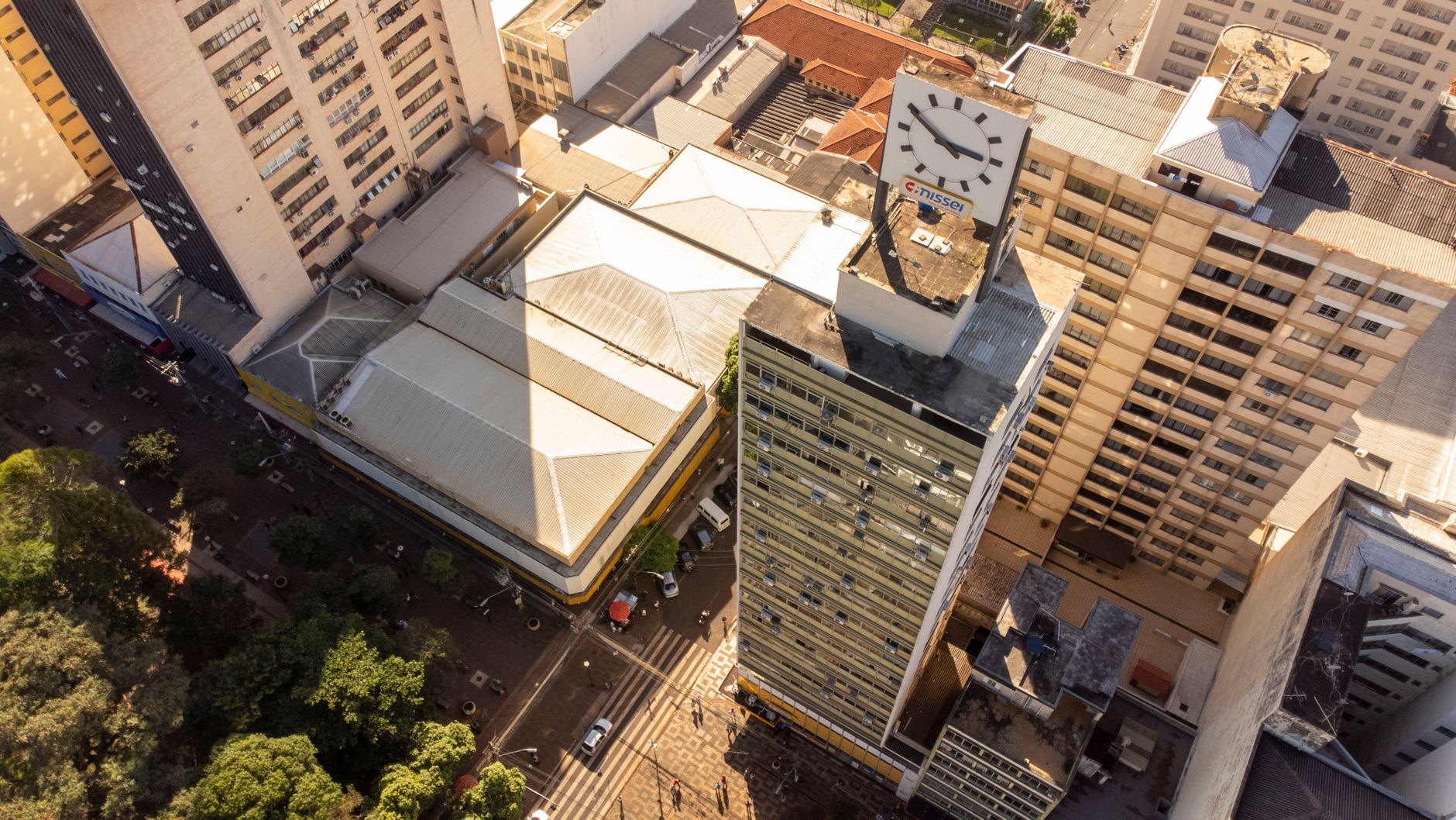 Aerial view of downtown Londrina showcasing skyscrapers and a prominent clock tower during the day.