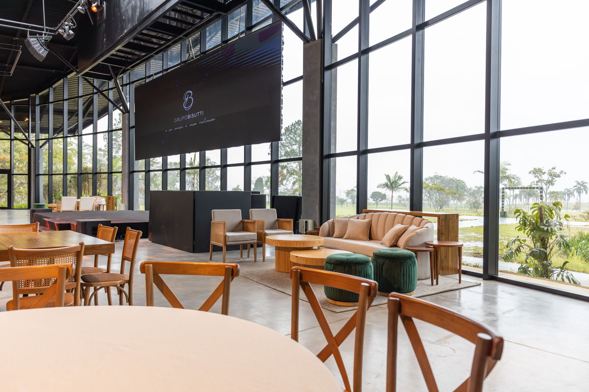 Spacious conference hall featuring modern furniture and large windows with a scenic outdoor view.