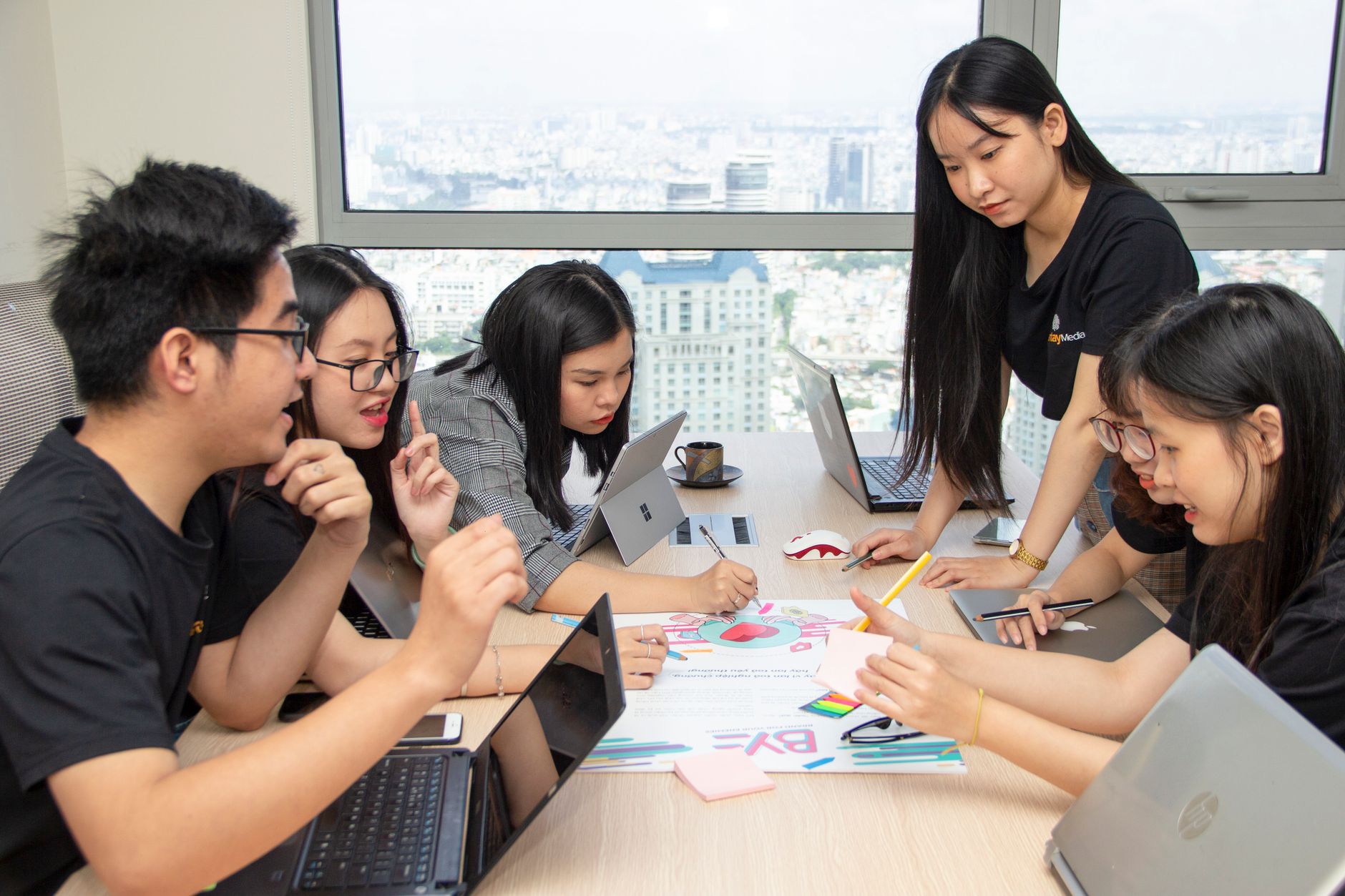 Team of young professionals collaborating creatively in a modern office space.
