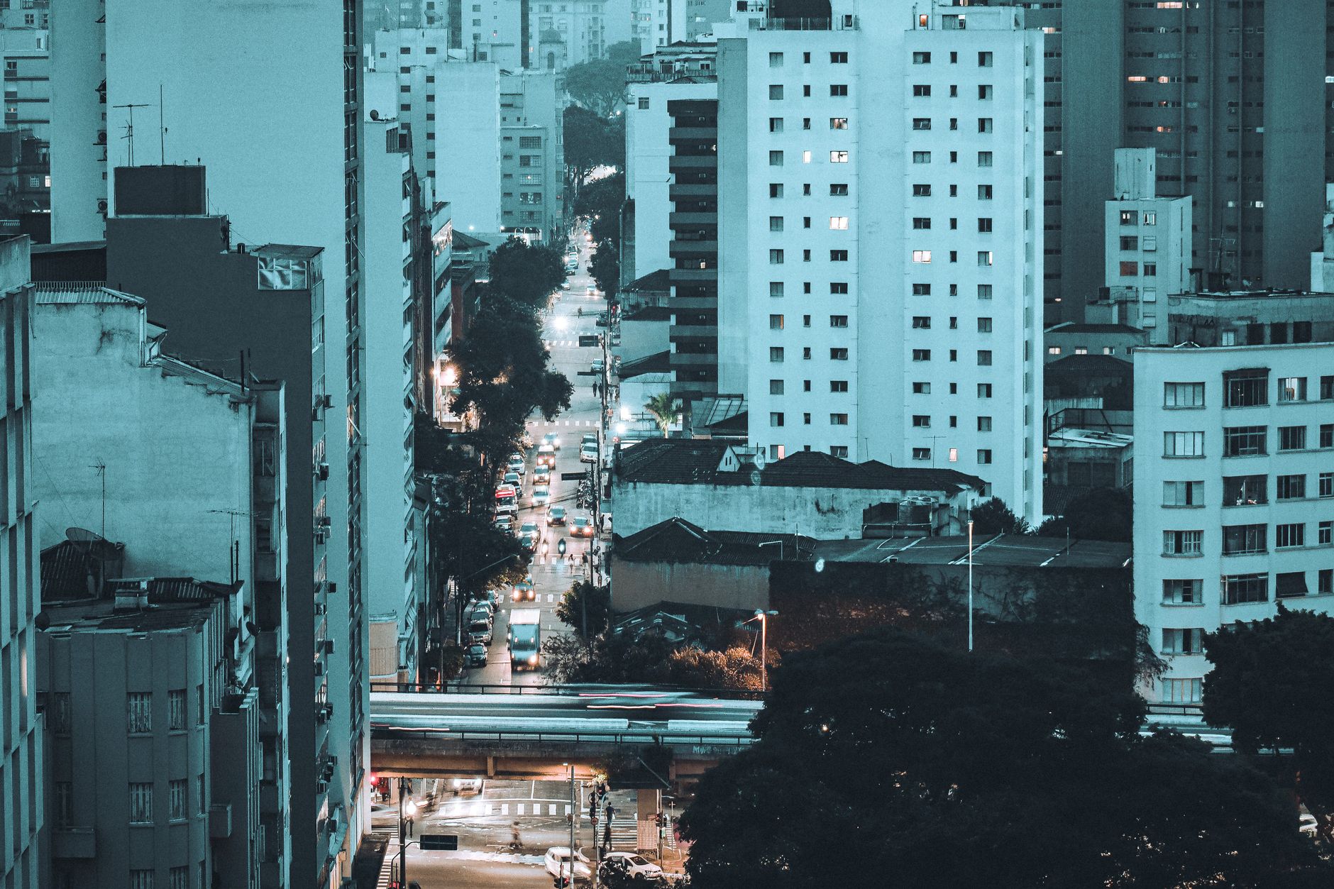 Vibrant cityscape of São Paulo at night, showcasing urban architecture and bustling streets.