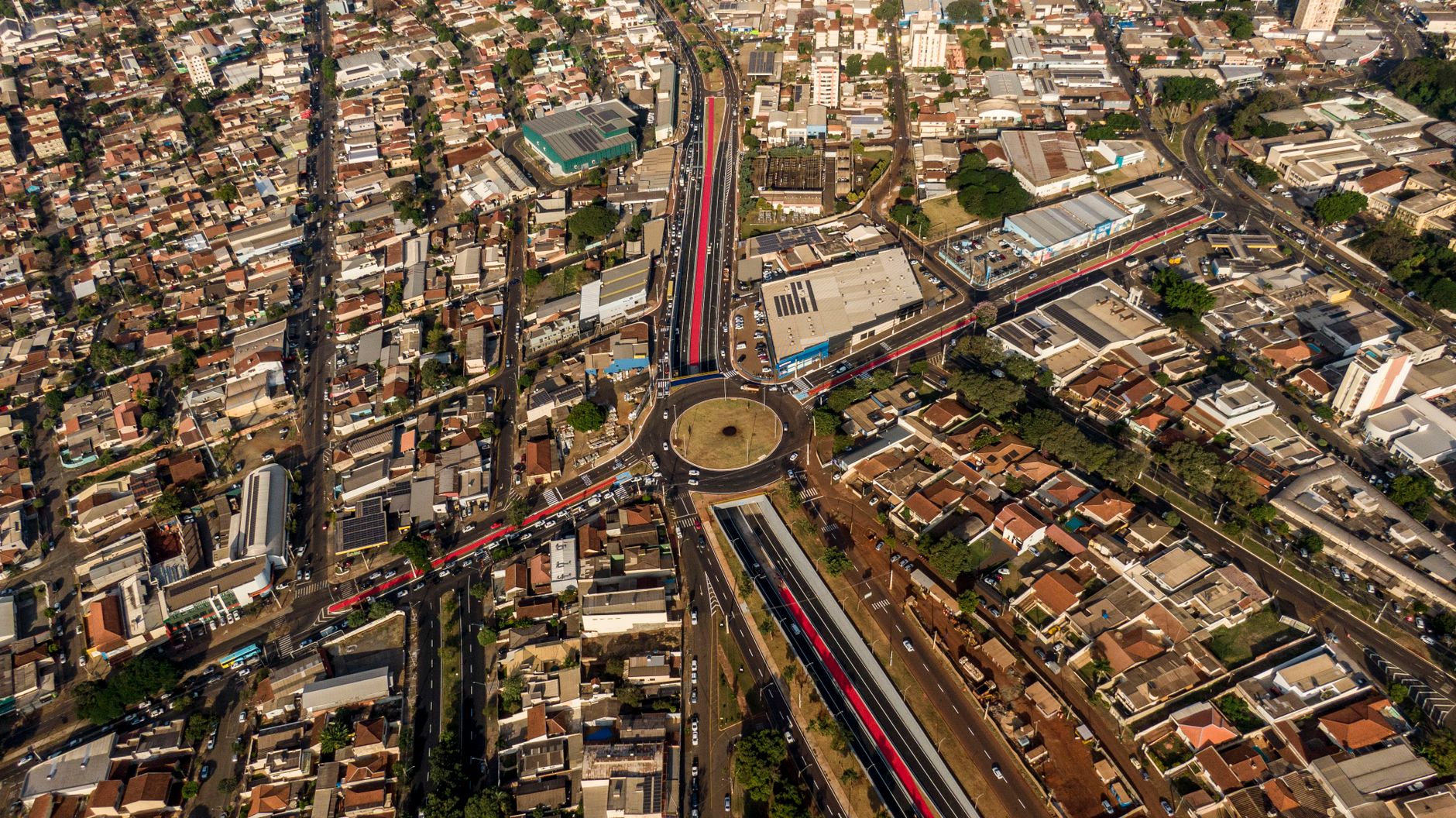 High-angle aerial view of a roundabout in Londrina, Brazil, capturing bustling urban life.
