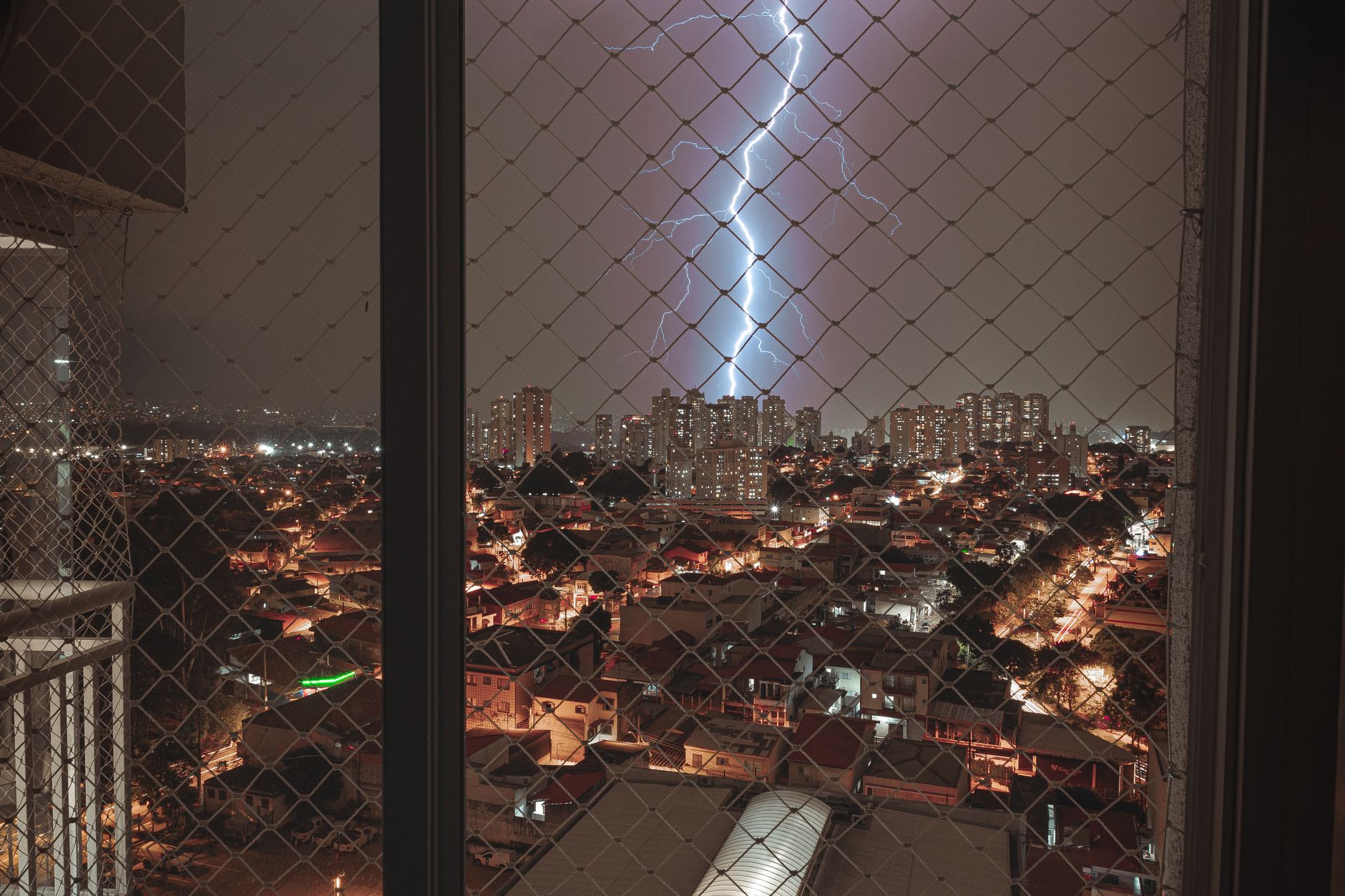 Captivating night cityscape with dramatic lightning illuminating a vibrant skyline.