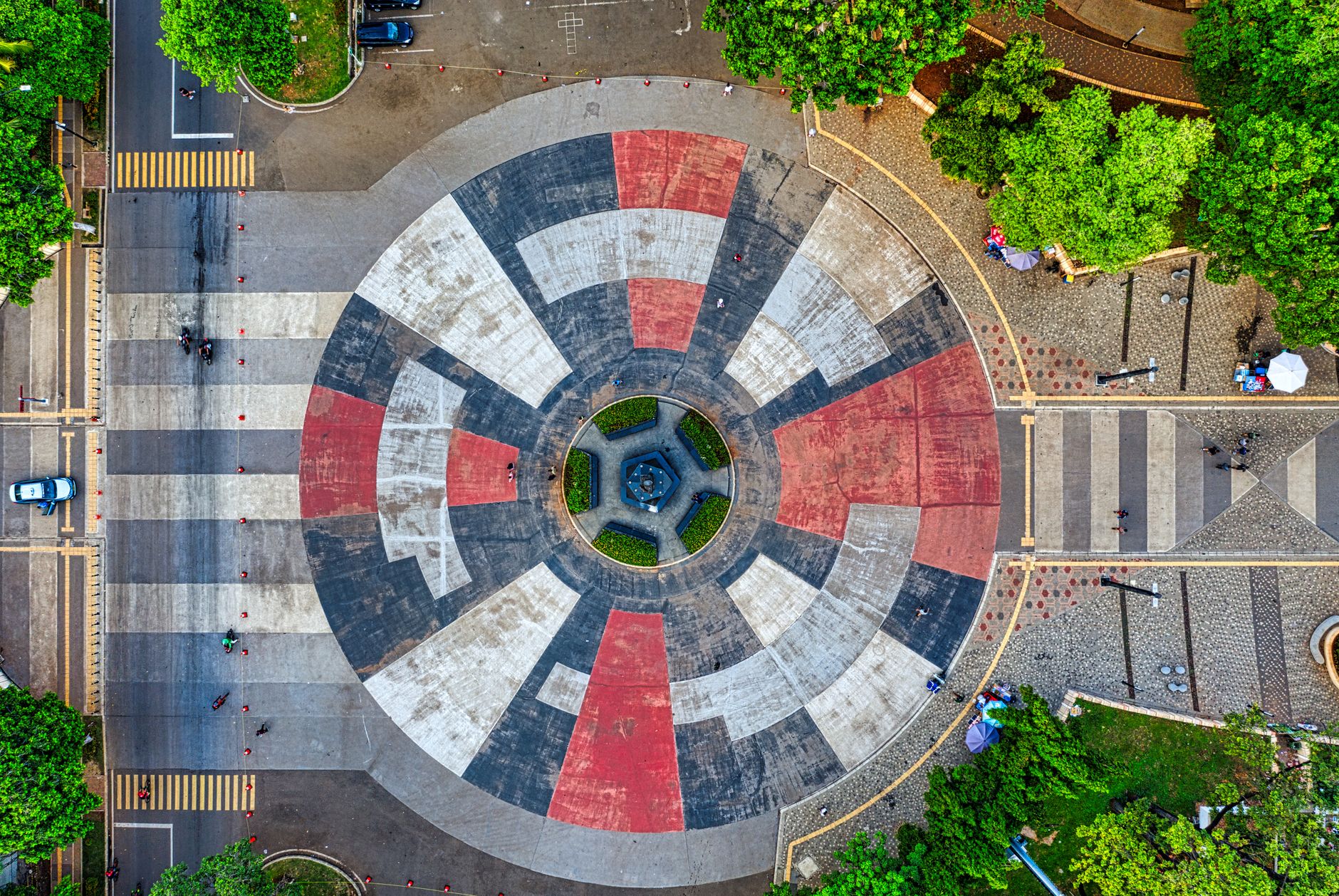 Stunning aerial view of a colorful circular park in Jakarta, showcasing unique patterns and vibrant greenery.