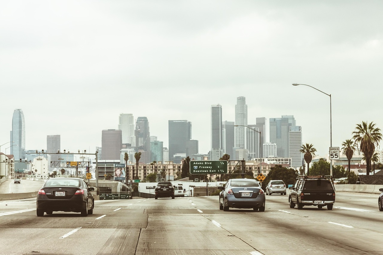 highway, cars, traffic, vehicles, towers, buildings, skyscrapers, los angeles, downtown, center, nature, freeway, office center, city, megalopolis, business centre, architecture, office, high-rise, multistory building, motion, road, asphalt, street, transport, sky, panorama