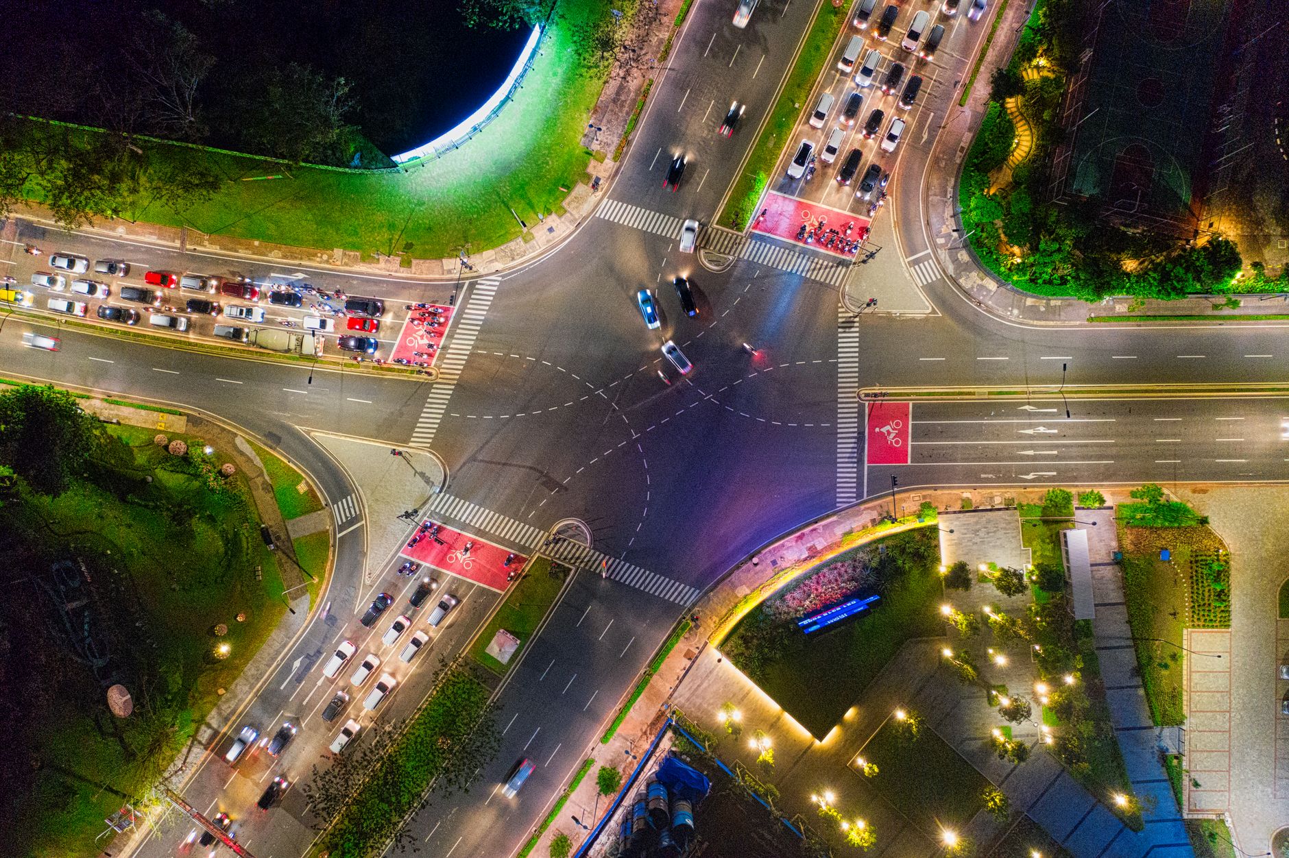 Dynamic aerial view of a busy traffic intersection in Banten, Indonesia, illuminated by city lights.