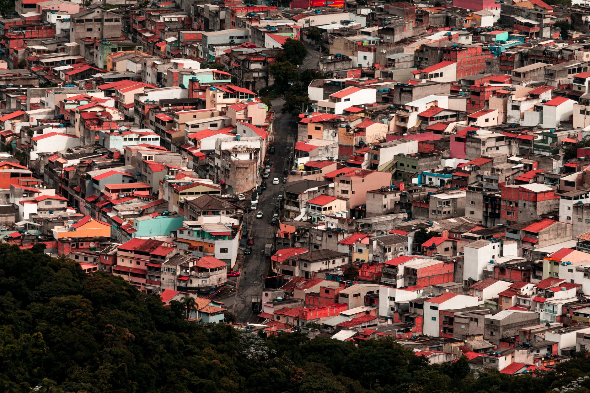 High-angle shot of a colorful, dense urban residential area with diverse architecture.