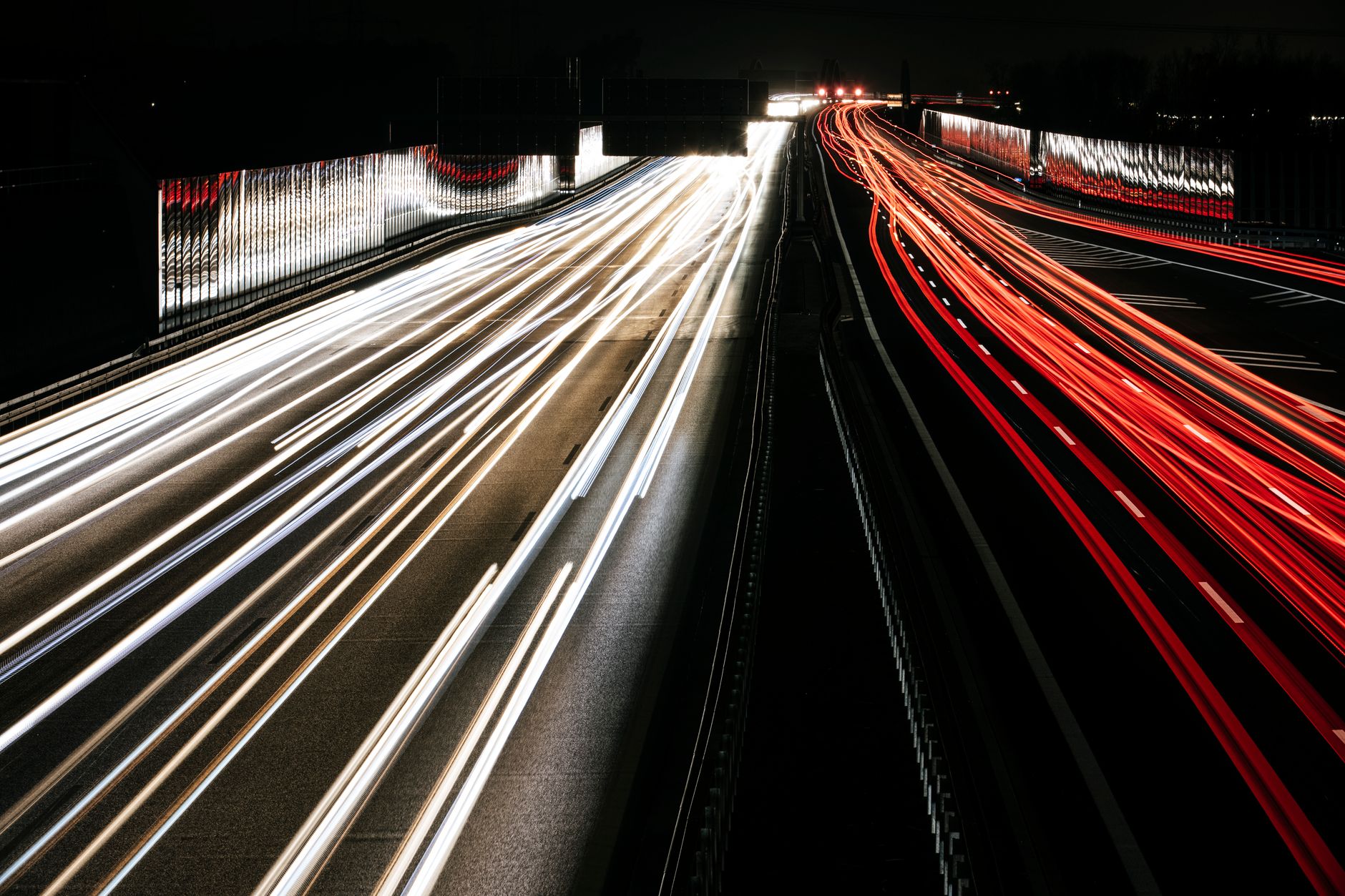 Captivating long exposure of highway light trails at night, showcasing speed and motion.