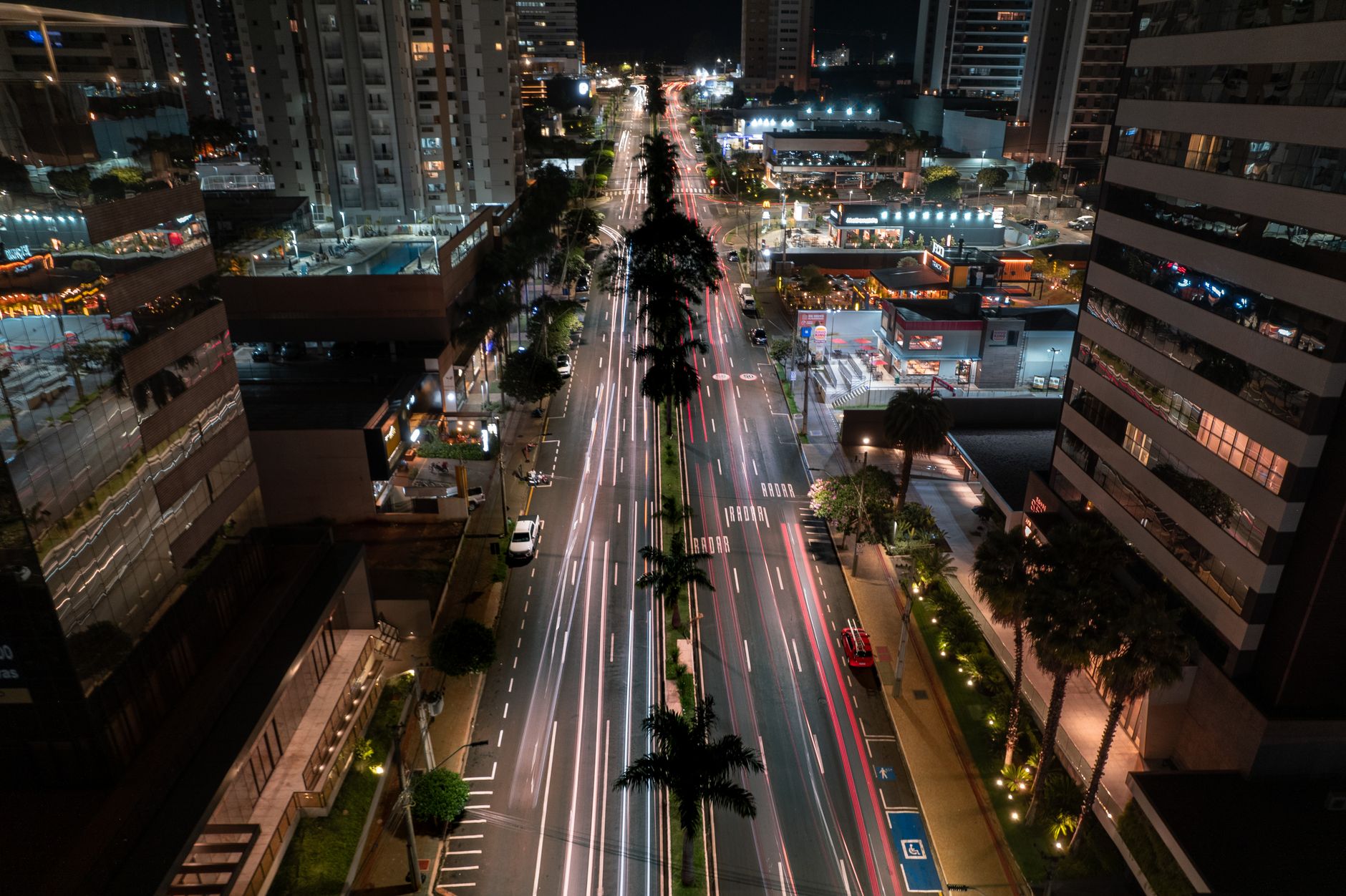 A vibrant aerial view of Londrina's illuminated city streets and modern architecture at night.