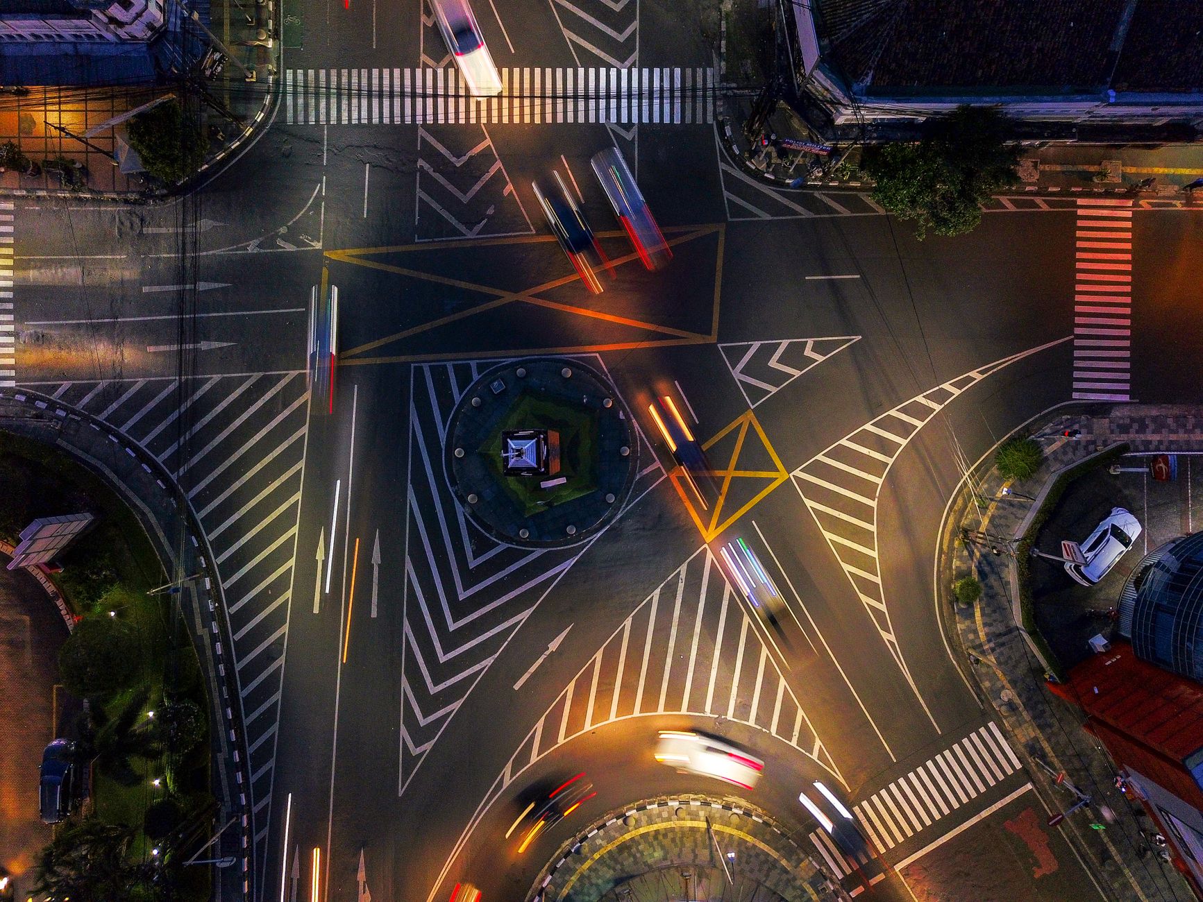 Aerial shot of illuminated intersection in Jawa Barat, Indonesia at night
