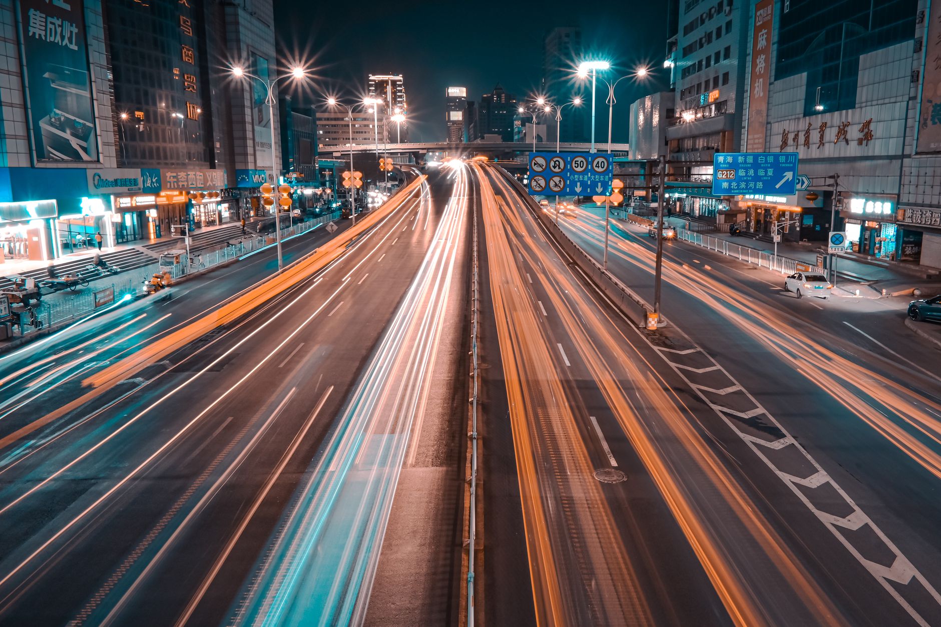 Captivating long exposure of urban traffic light trails in a bustling city at night.