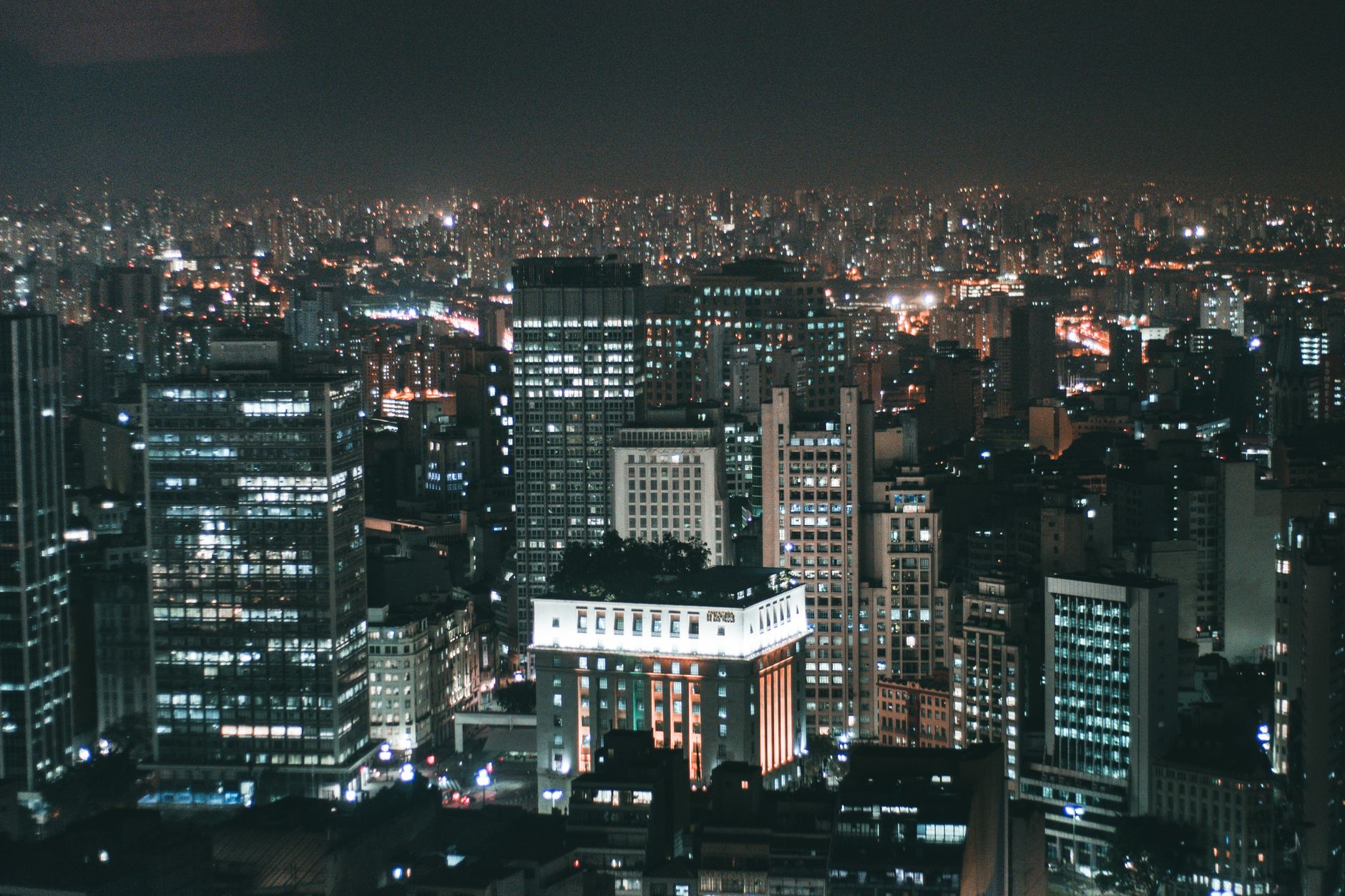 Captivating view of São Paulo cityscape illuminated at night, showcasing skyscrapers and bustling urban life.
