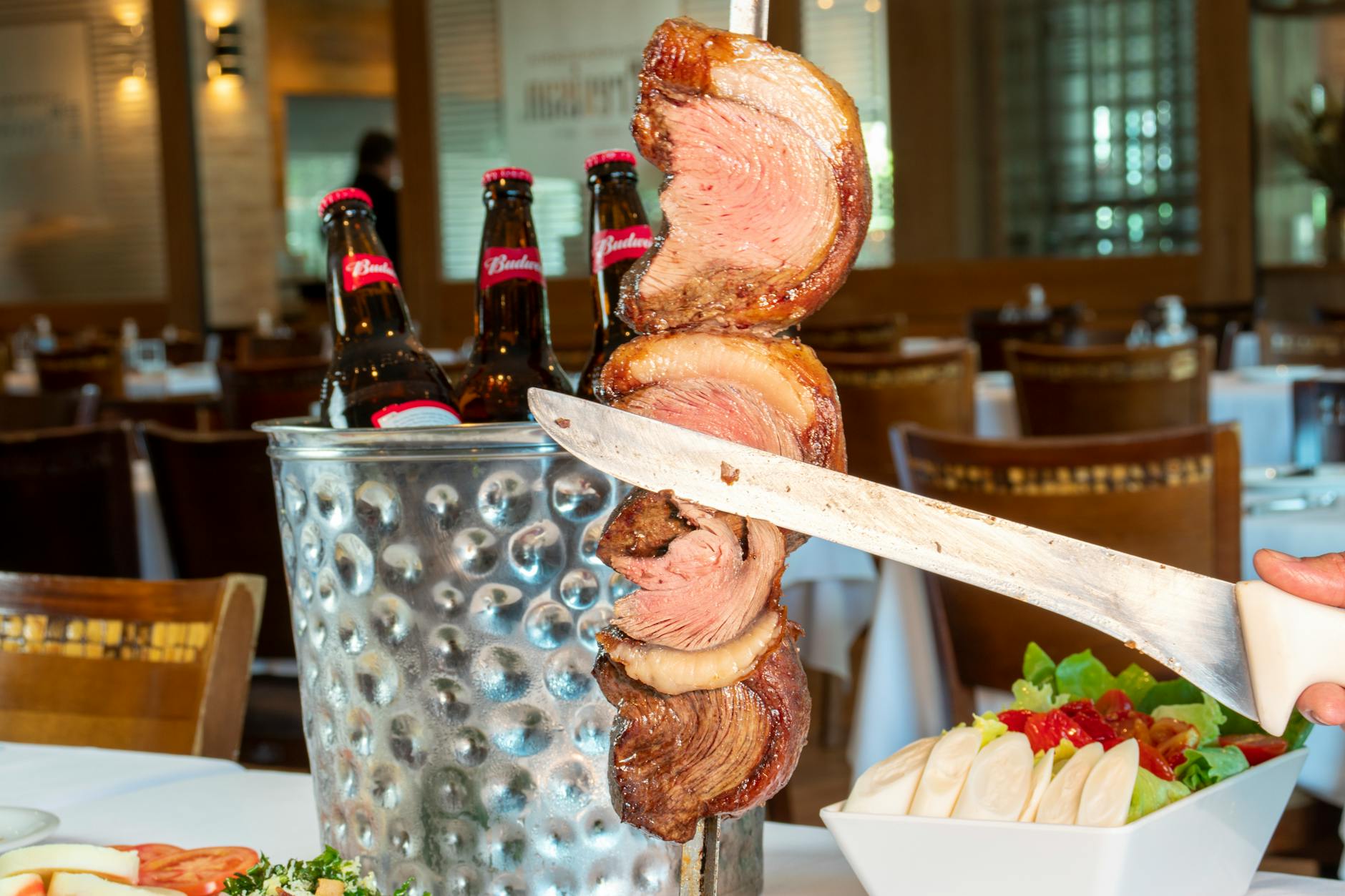 Savor the authentic taste of Brazilian churrasco with refreshing beers in a cozy São Paulo restaurant.