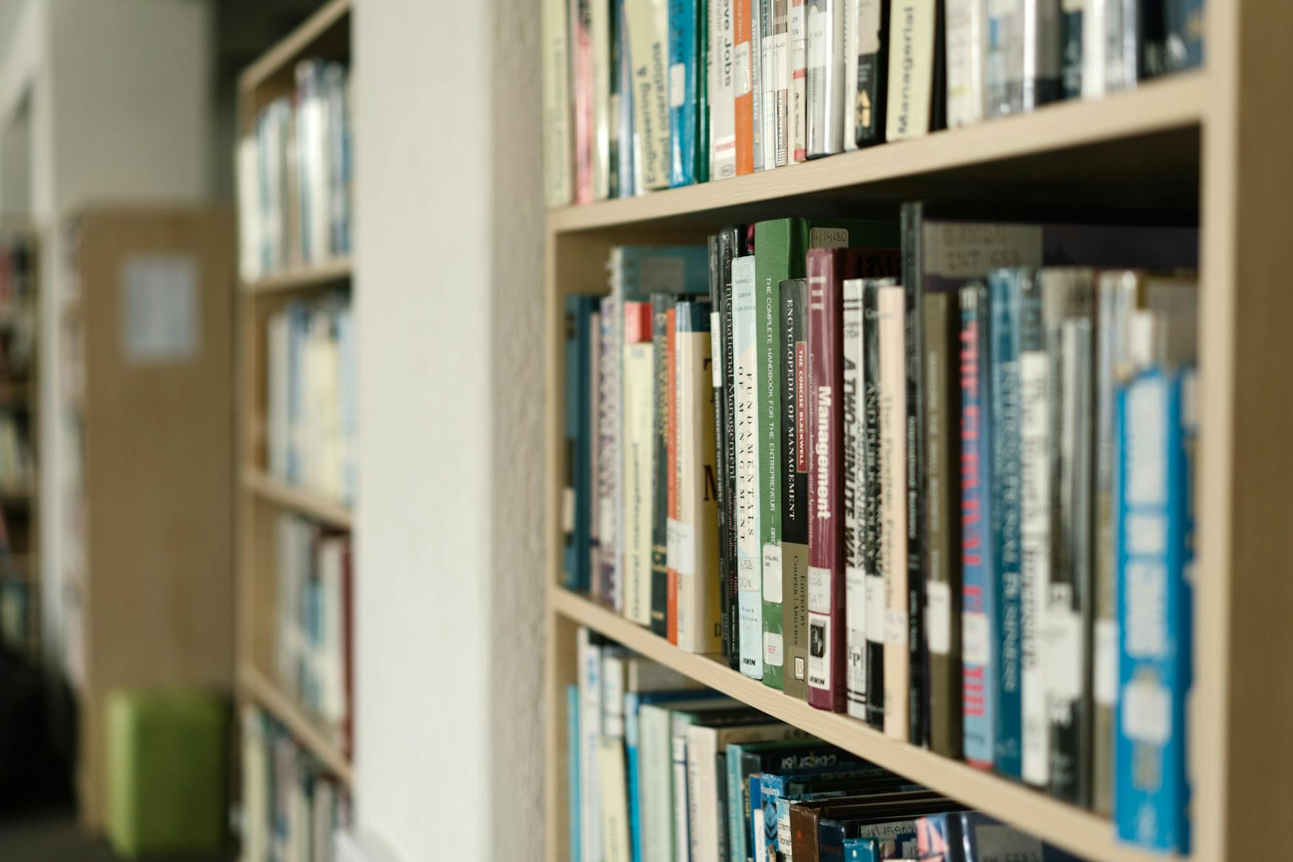 Close-up of bookshelves filled with diverse literature in a quiet library setting.