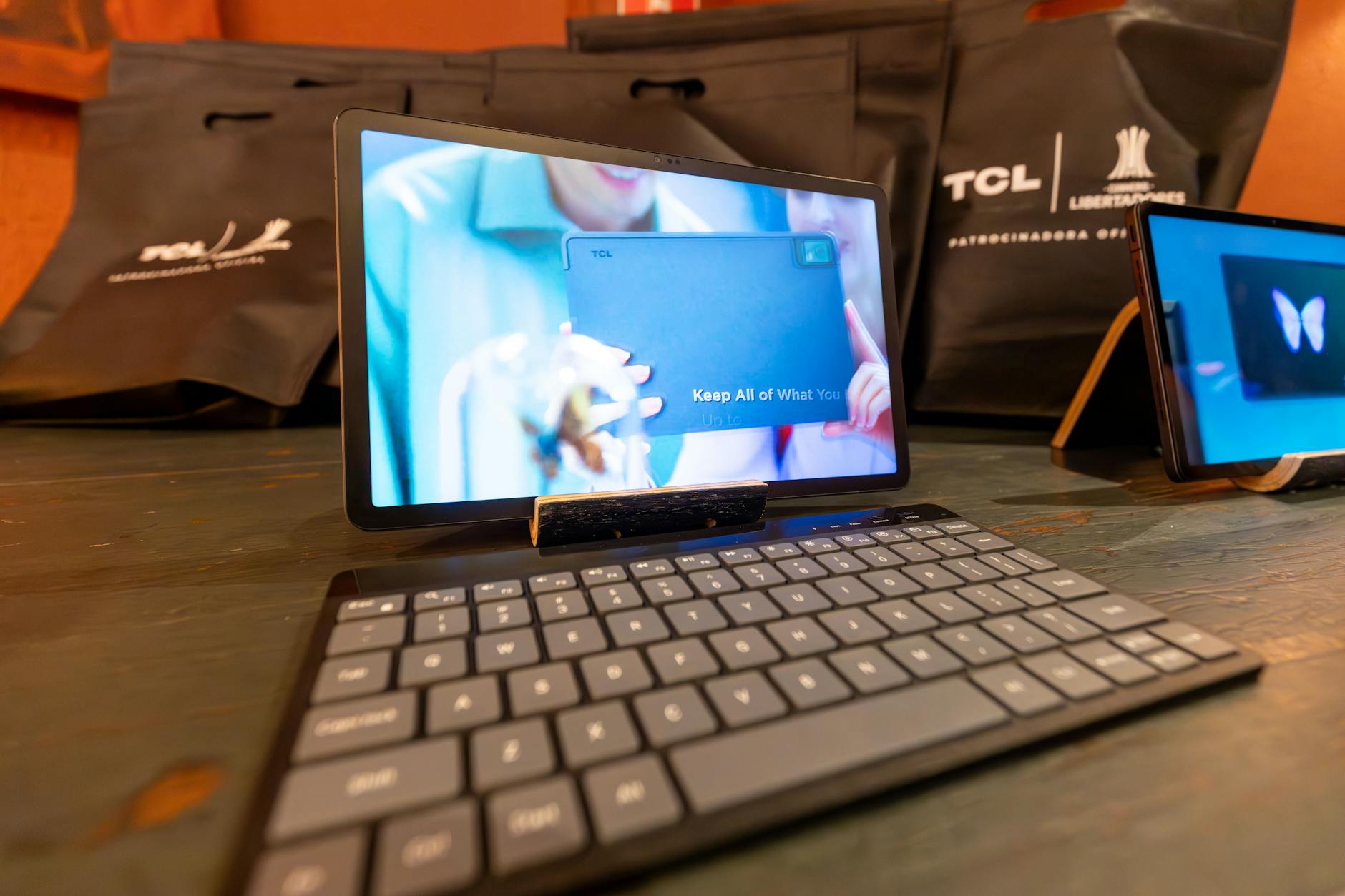 High-quality image of a tablet with a wireless keyboard in a tech showcase setting.