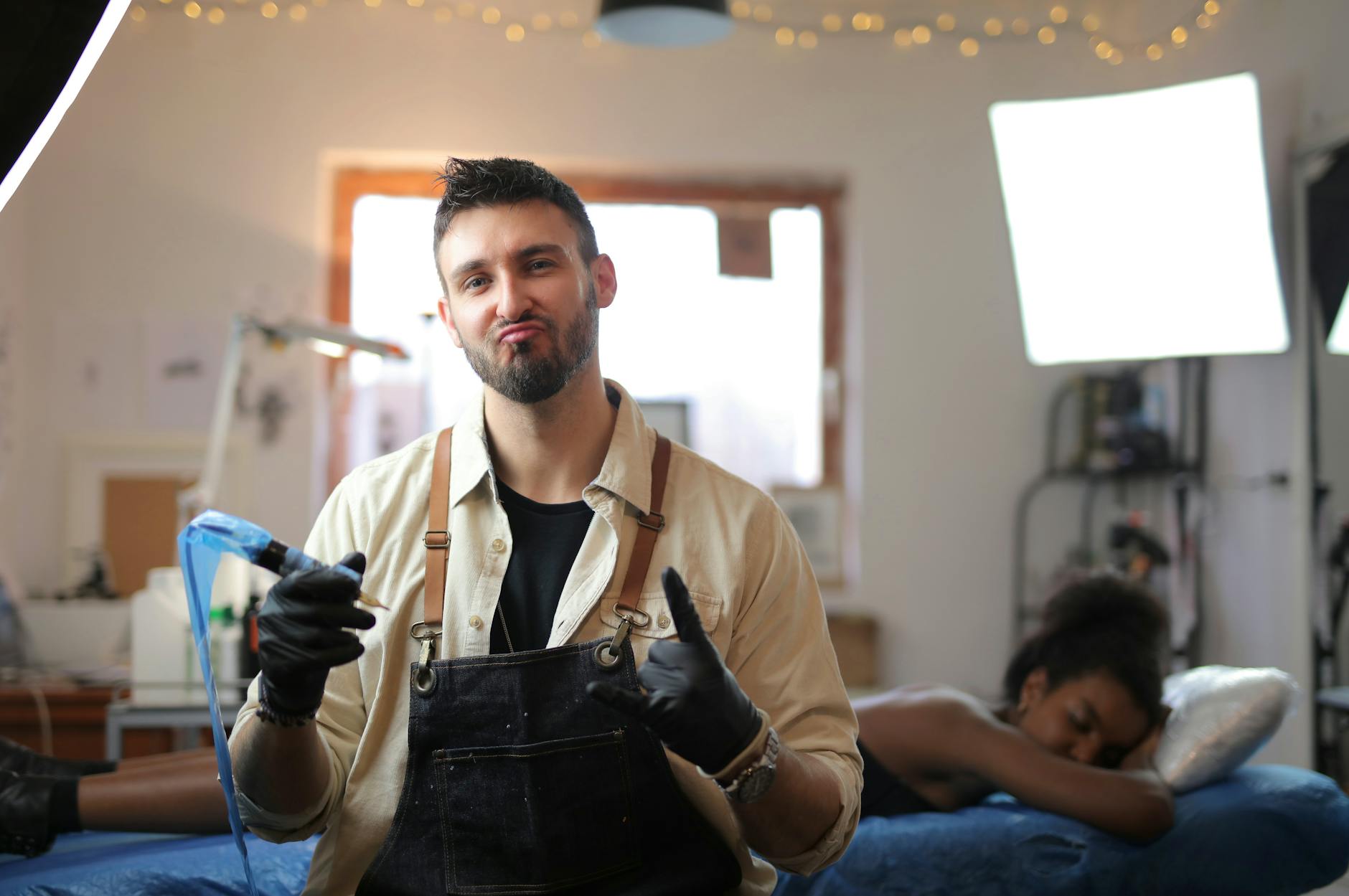 Confident tattoo artist in a studio, preparing to create art on a client.
