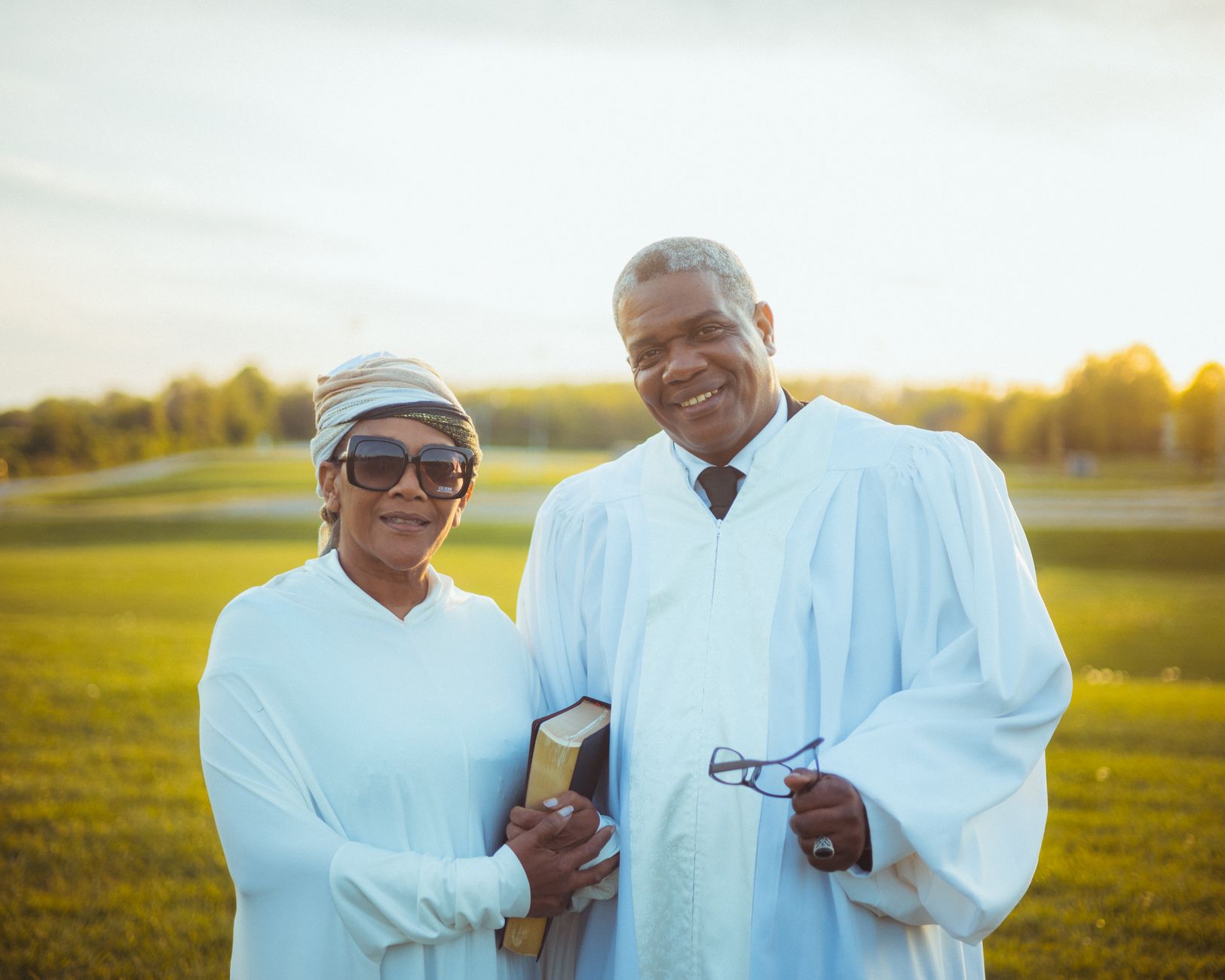 Outdoor crusade with minister using scheduling tablet on stage