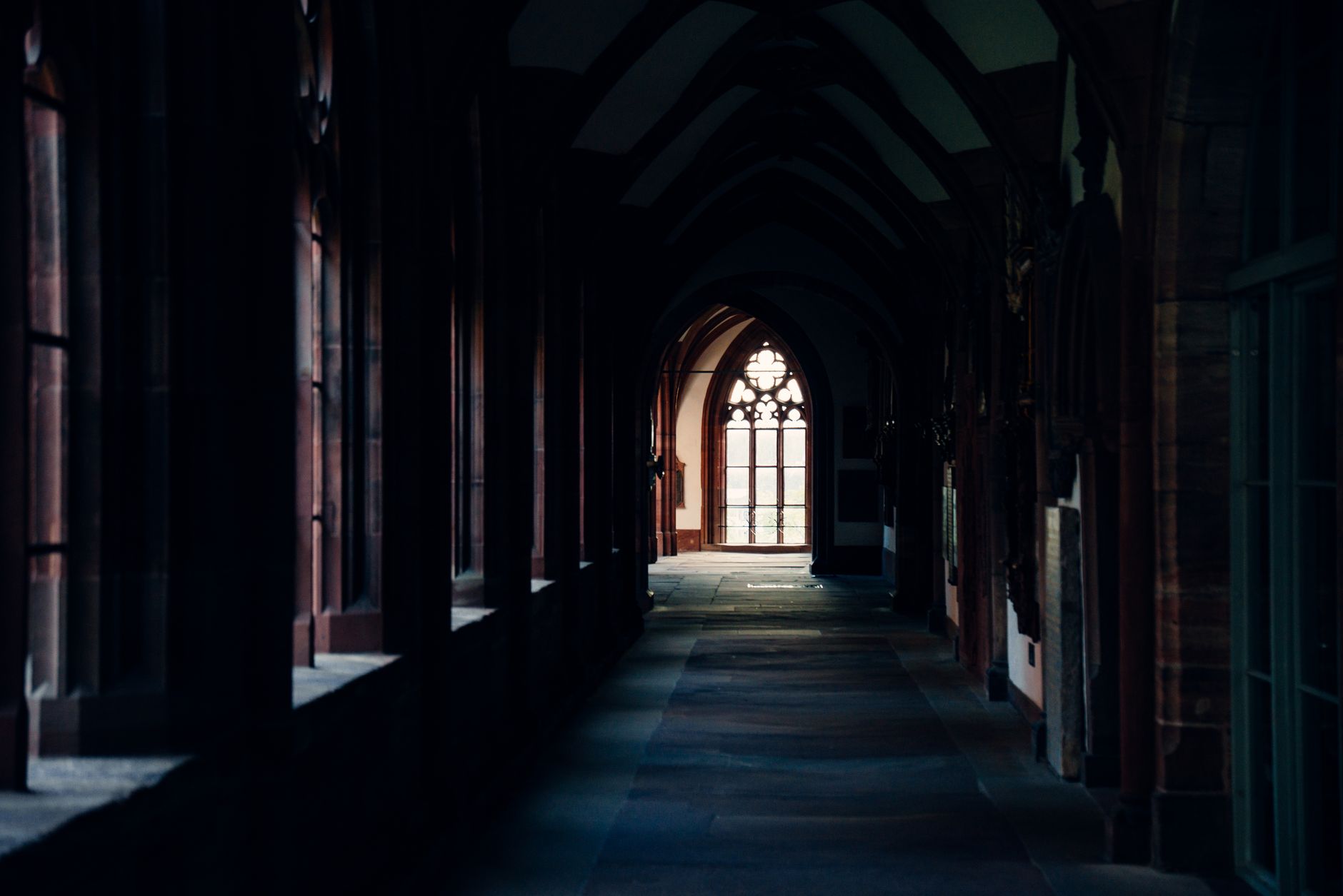 View of a historic gothic church corridor in Basel, showcasing architectural beauty.