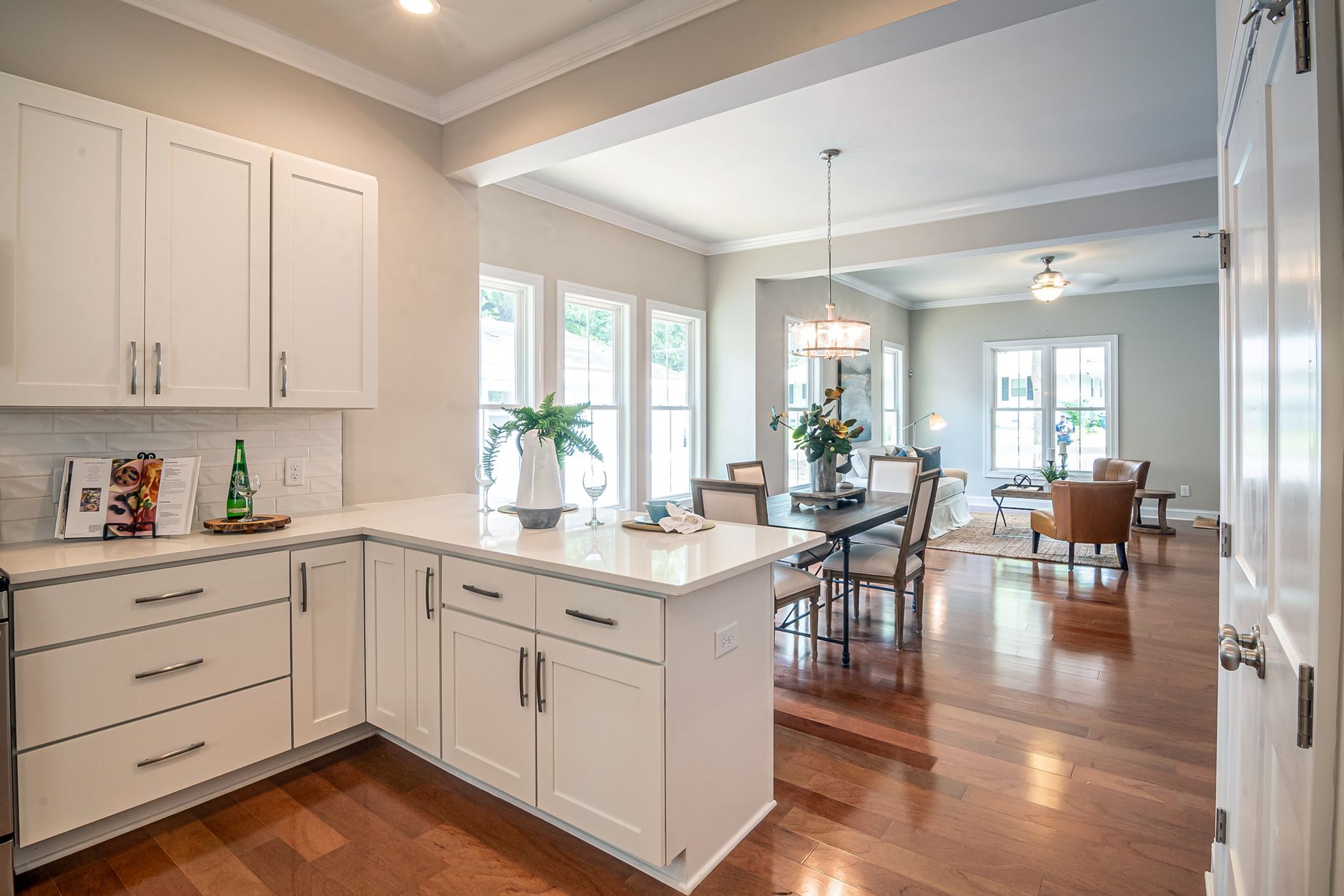 Bright open-concept kitchen and living room showcasing modern interior design and natural light.