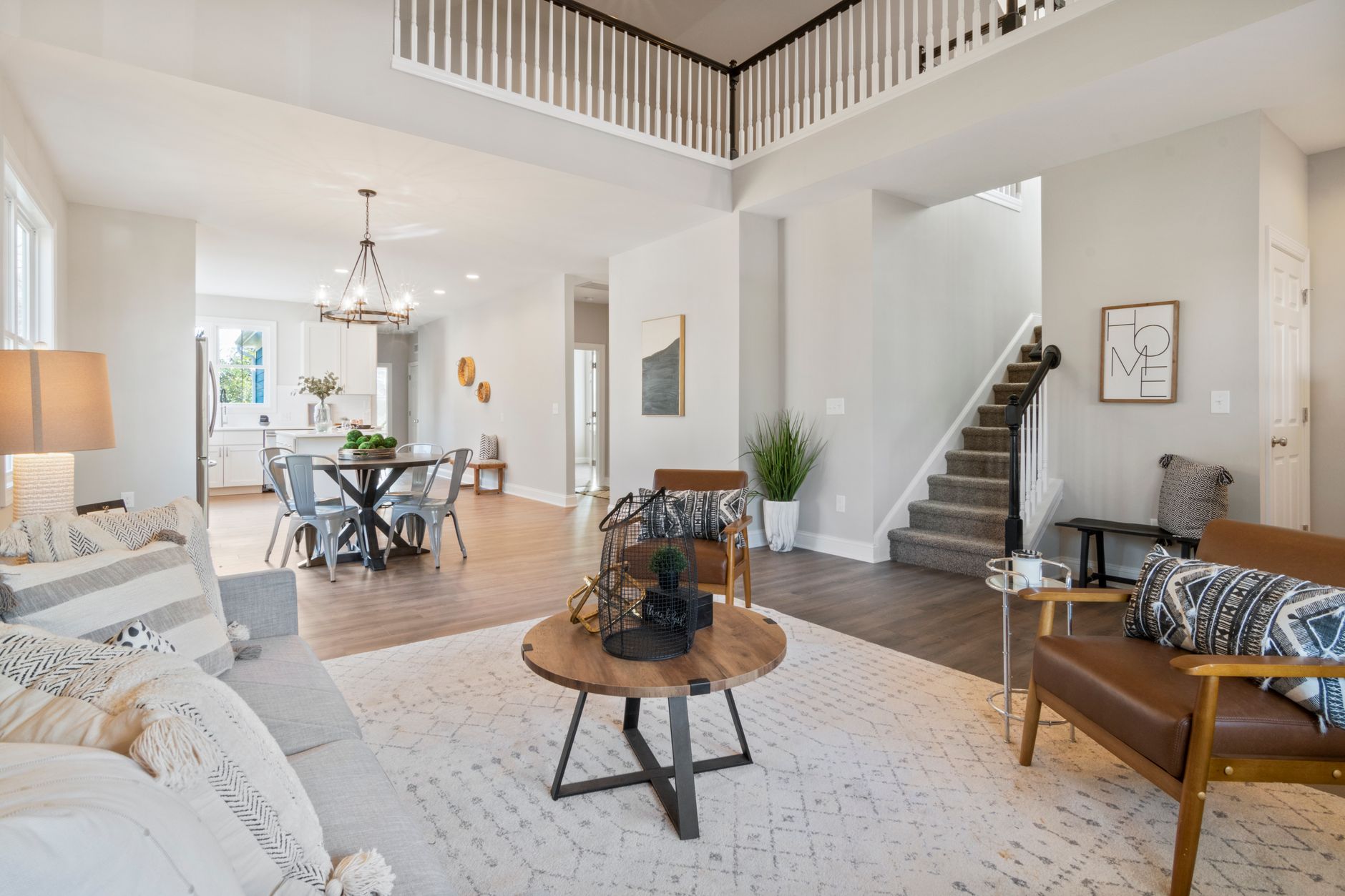 Bright and elegant open concept living room featuring modern furniture and decor.