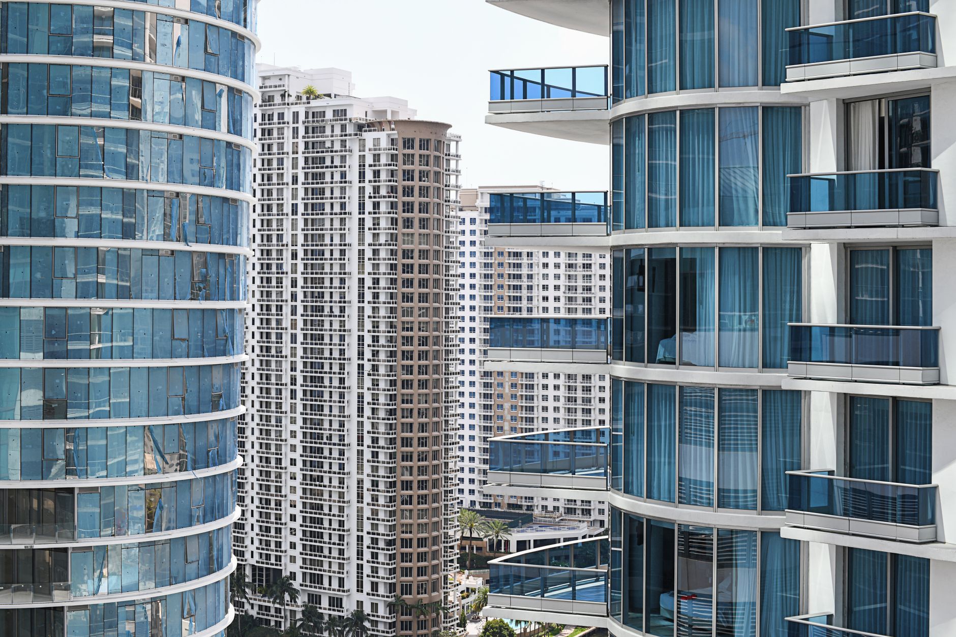 Contemporary cityscape showcasing modern high-rise buildings with glass balconies and facades.