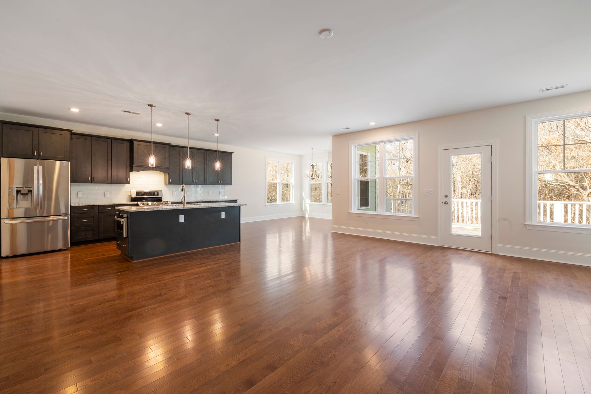 Bright and spacious kitchen with modern design and wooden flooring, perfect for contemporary homes.