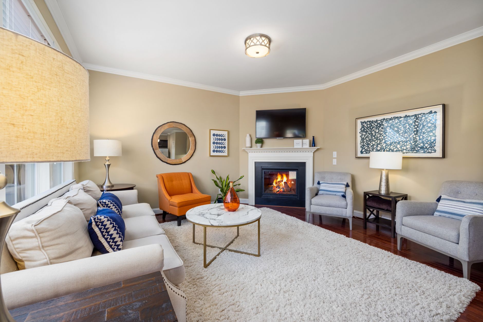 Elegant living room with a modern fireplace and stylish furniture in a cozy setting.