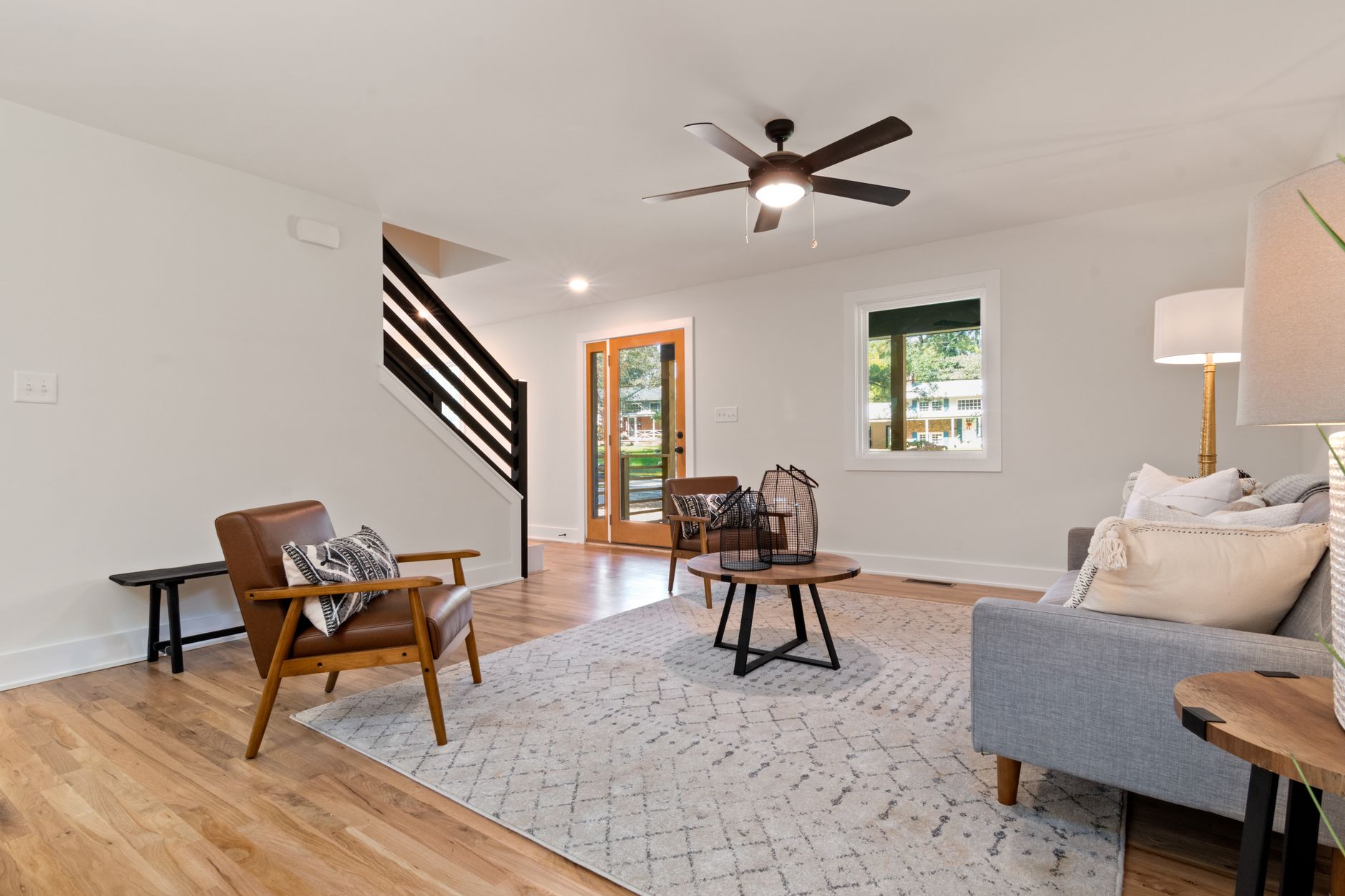 Spacious modern living room featuring neutral tones and elegant furnishings.