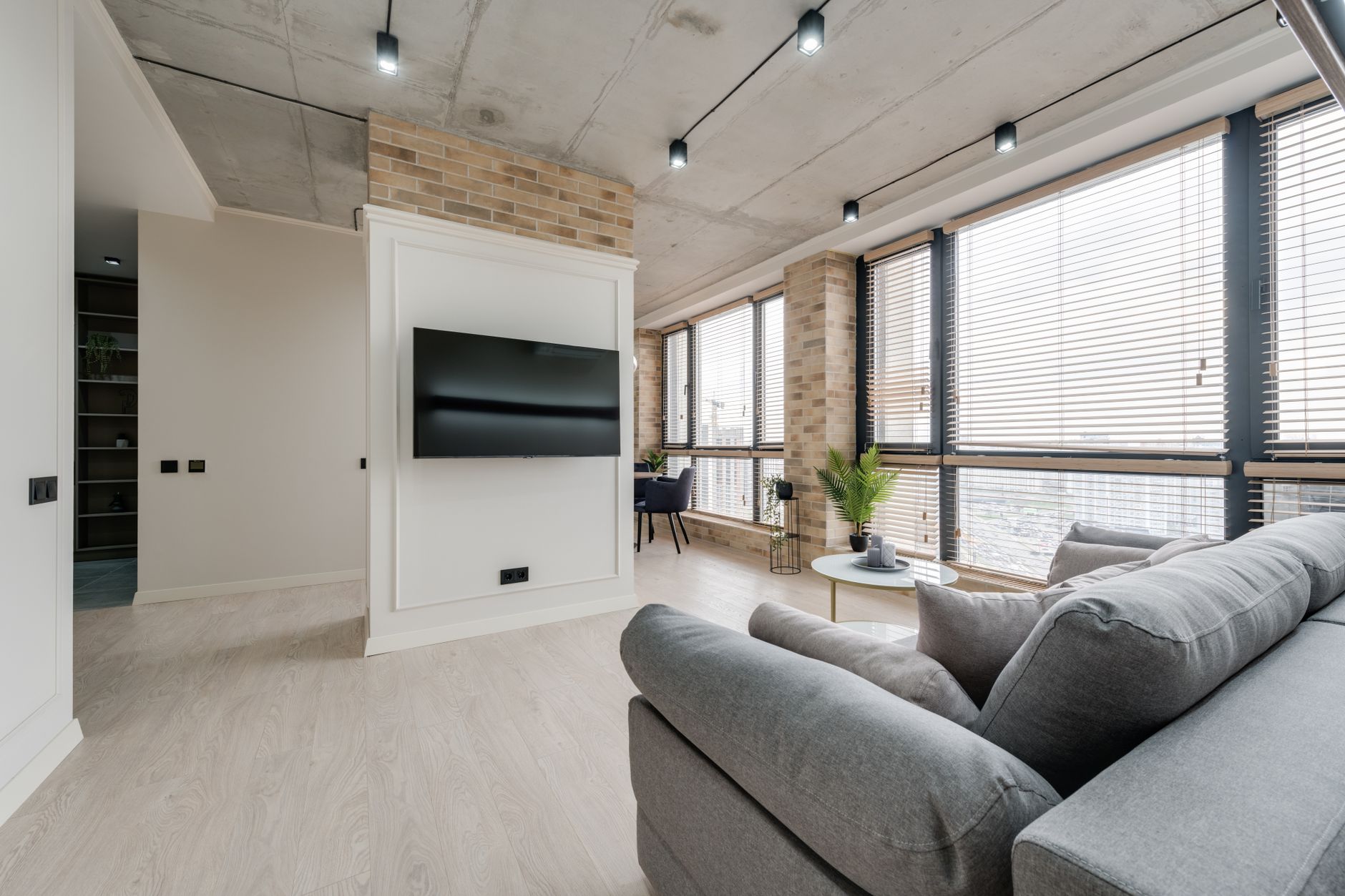 Bright modern living room with stylish decor and large windows.