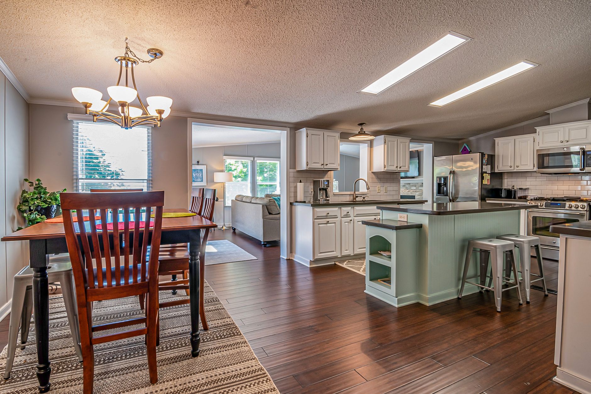 Spacious modern kitchen and dining room with elegant interior design elements and natural lighting.