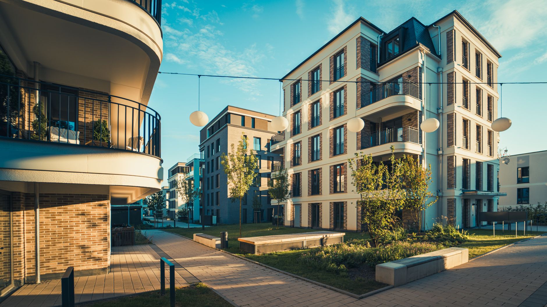 Contemporary urban housing complex showcasing modern architecture and open balconies in daylight.