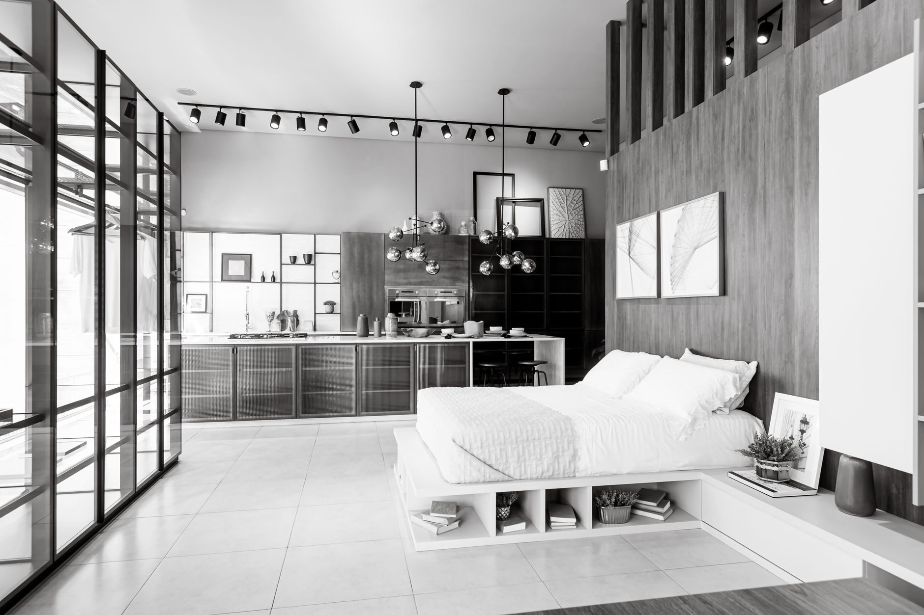 Elegant interior featuring a minimalist bedroom adjacent to a contemporary kitchen.