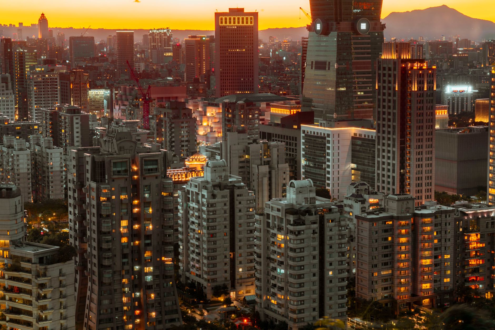 Stunning urban cityscape featuring modern skyscrapers illuminated at sunset, showcasing vibrant city life.