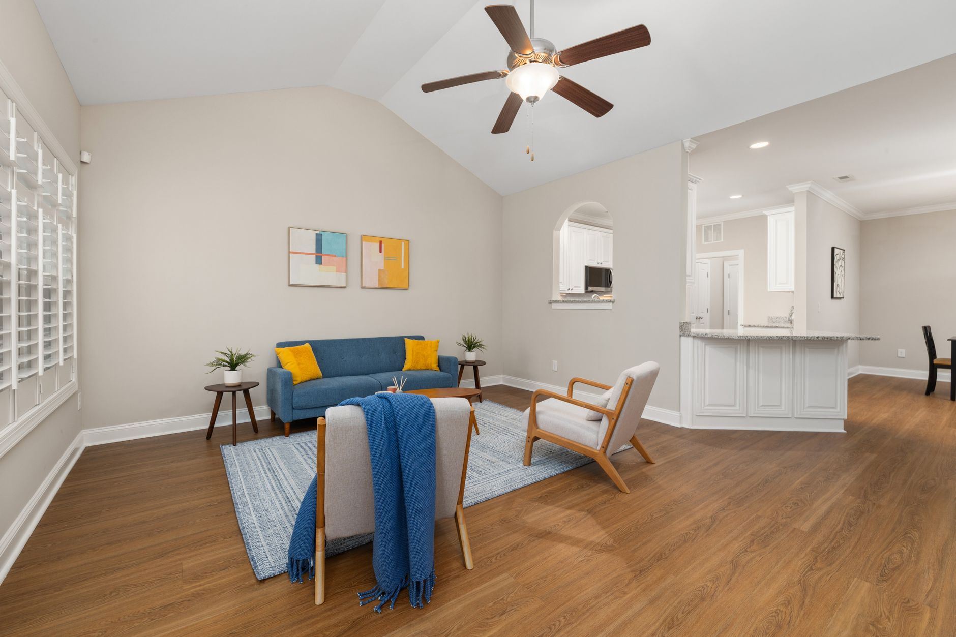 Spacious living room featuring modern furniture and decor with natural light.