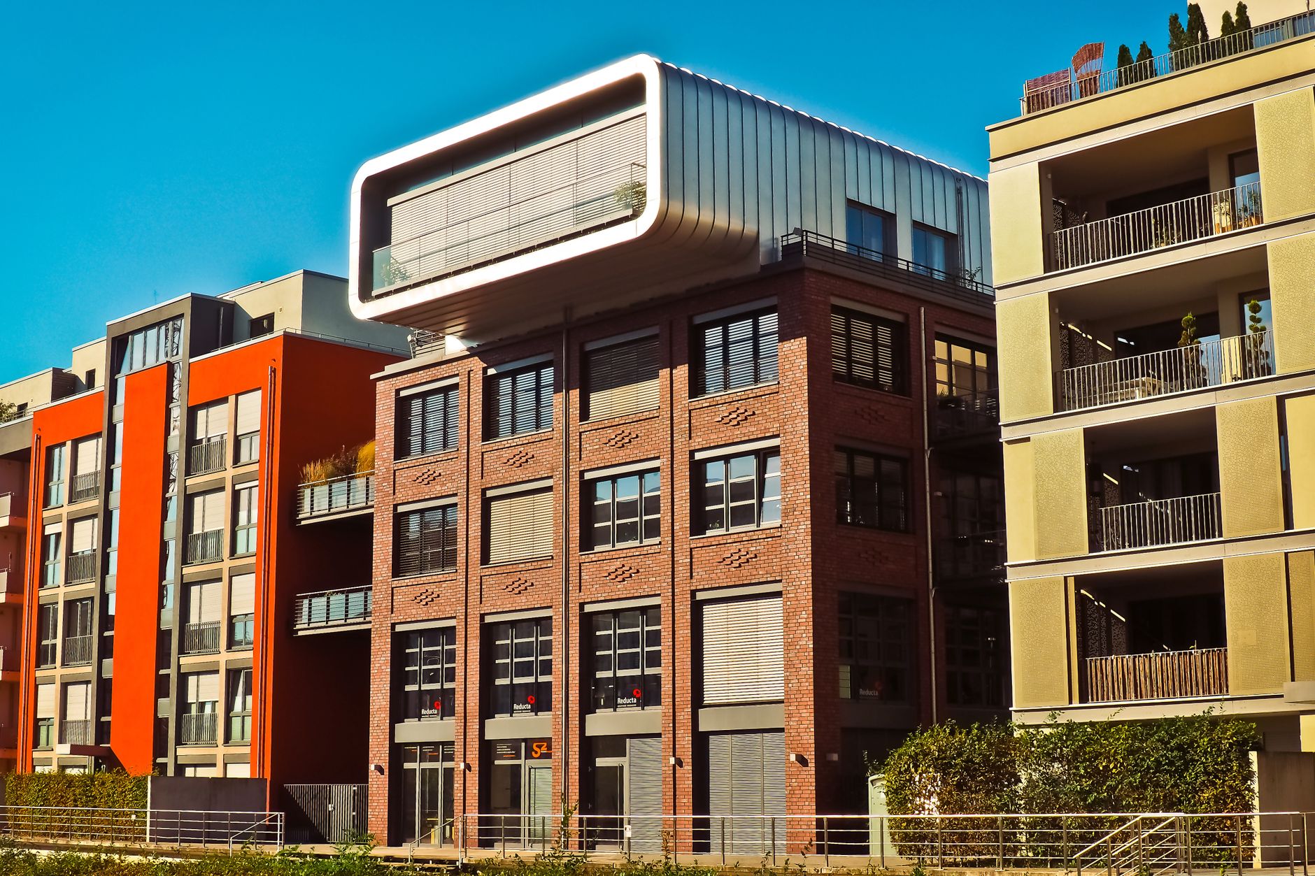 Stylish modern apartment buildings with unique design and architecture in a city setting.