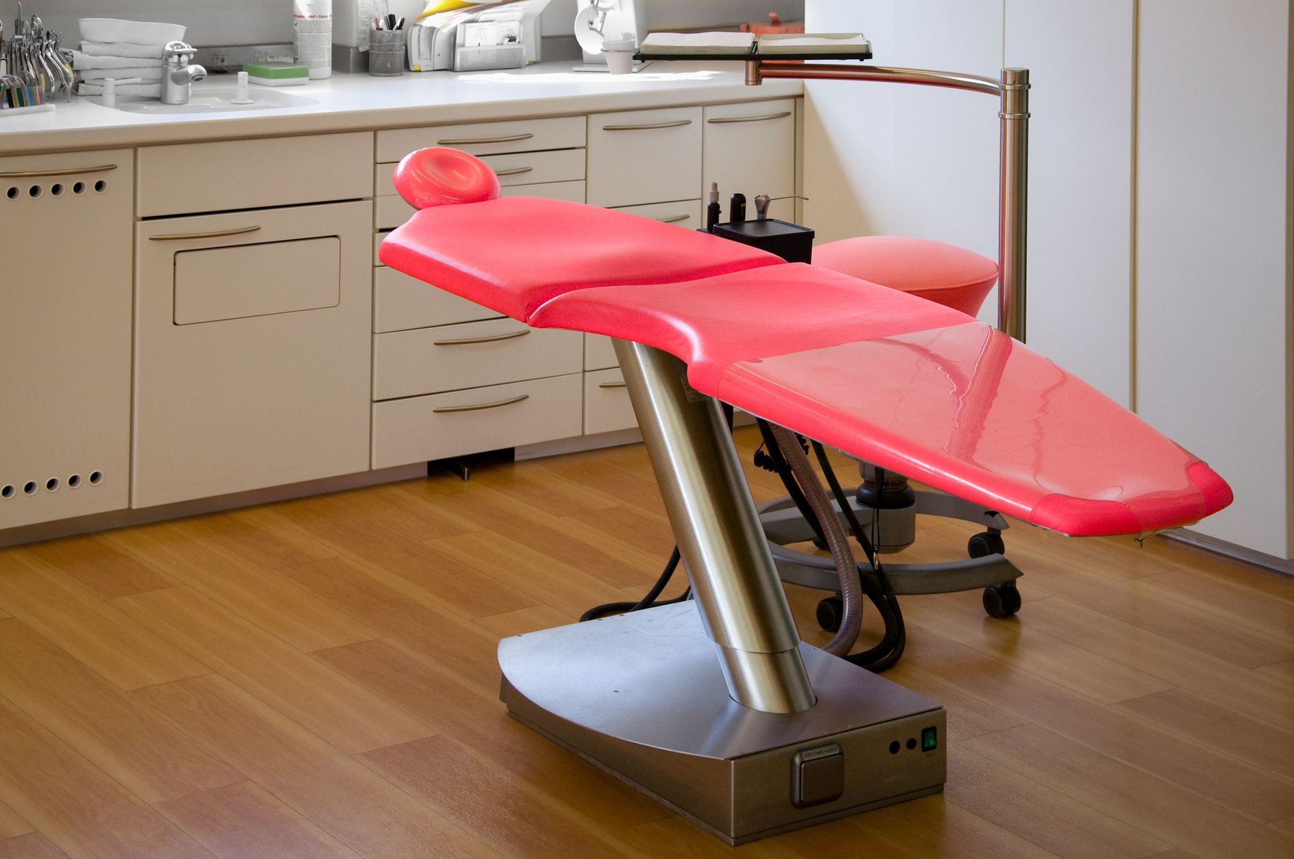 Bright modern dental chair in a well-organized dentist's clinic room.