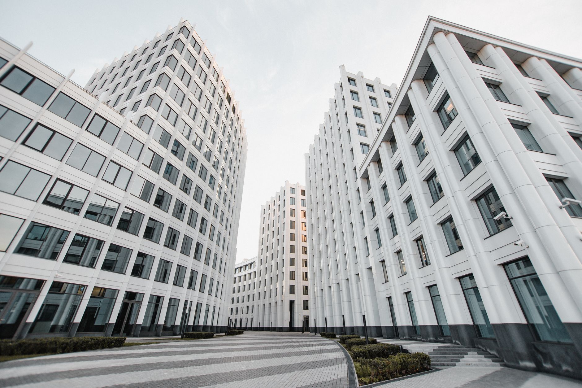 View of tall modern white buildings with glass windows forming a distinctive architectural style.