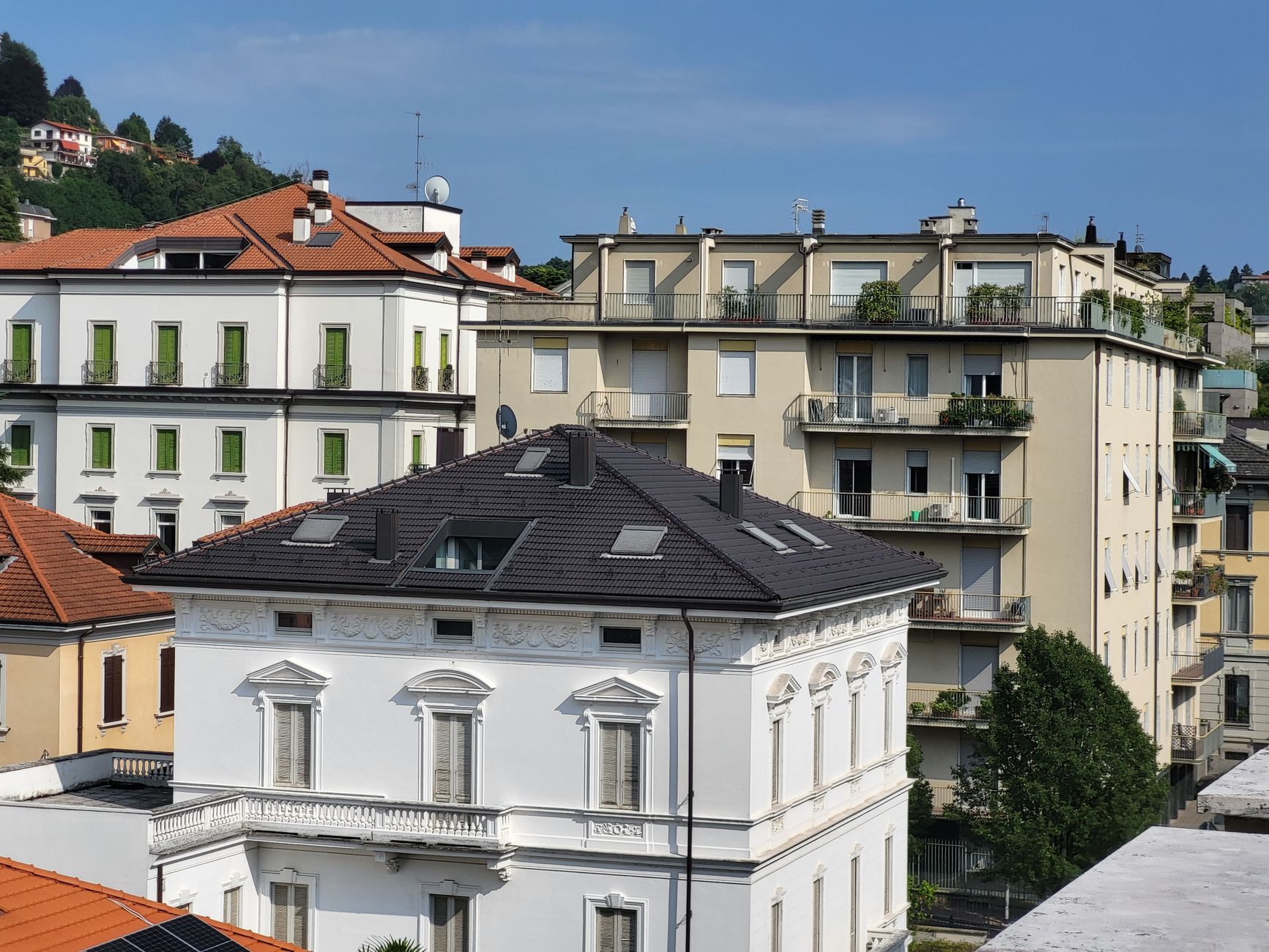 A scenic view of residential buildings with varied architecture styles in a cityscape.