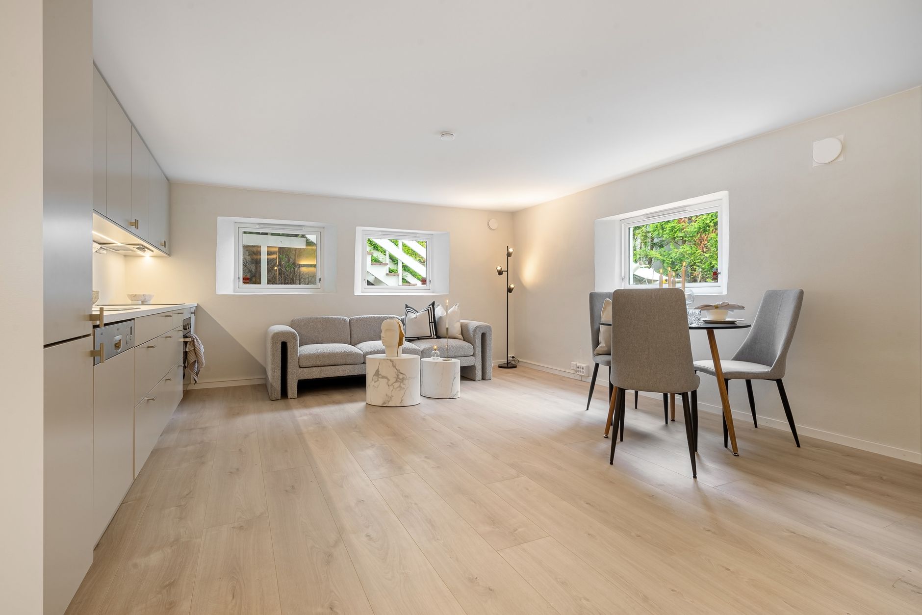 Spacious and bright modern living room with minimalist design and wooden flooring.