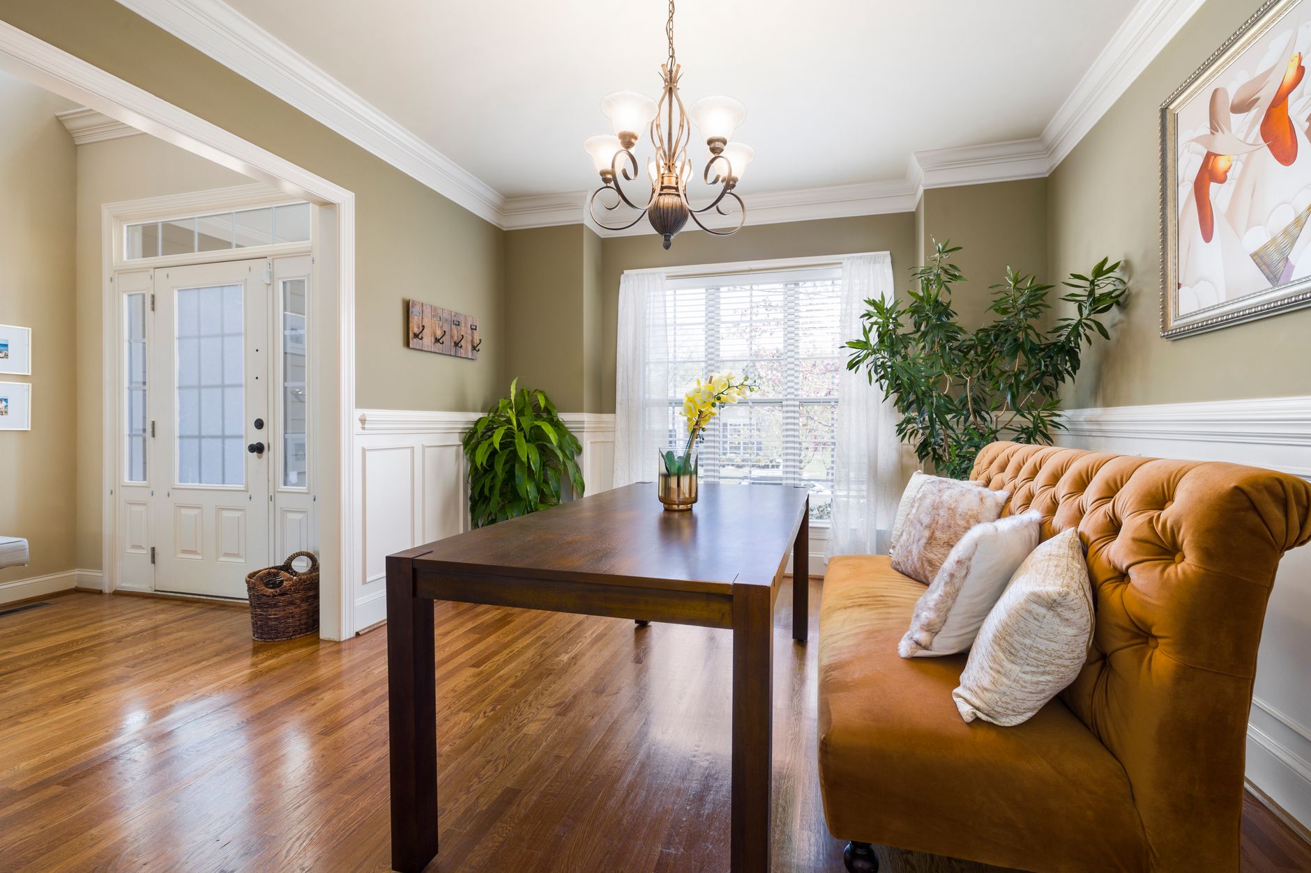 Bright dining room featuring a chandelier, windows, and elegant furniture in a cozy setting.