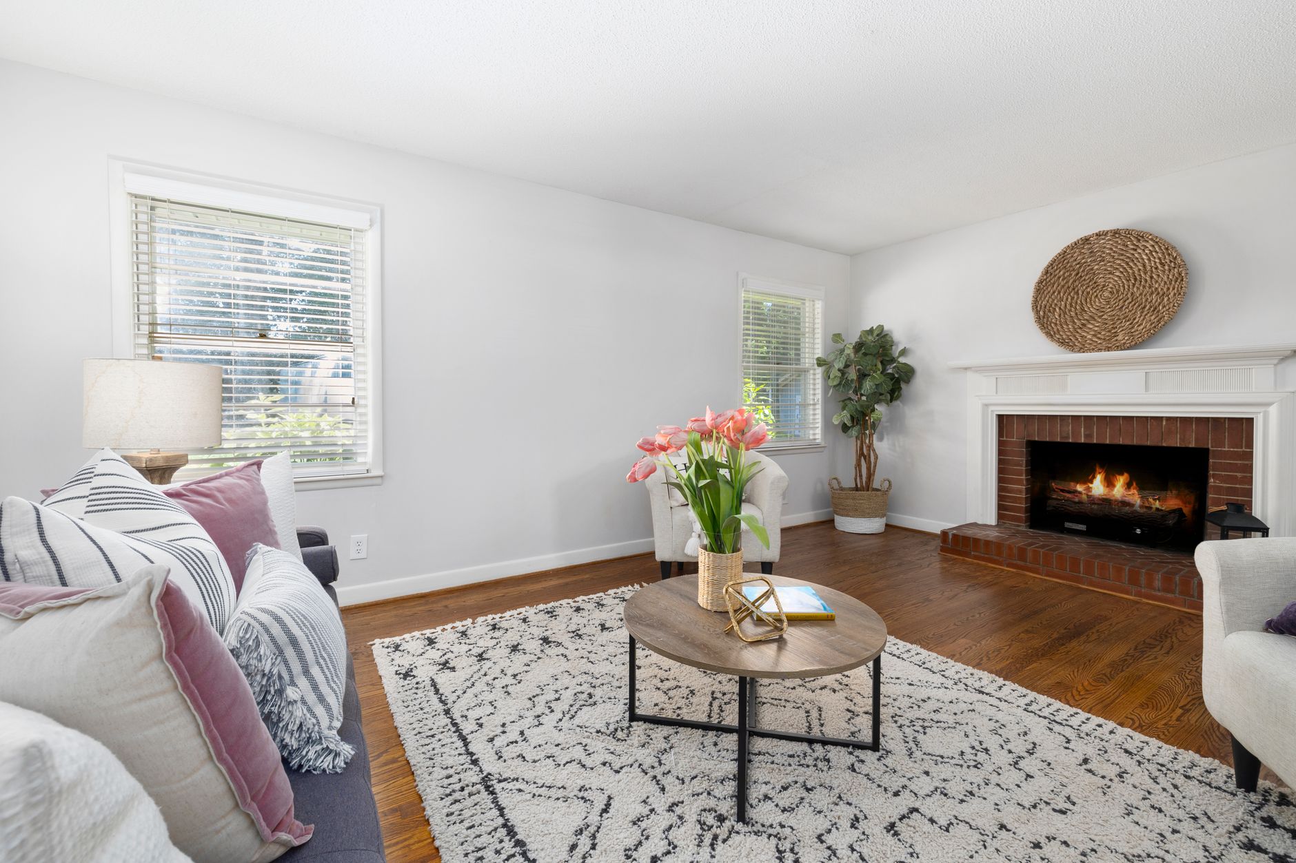 Modern living room featuring a stylish fireplace, cozy furnishings, and elegant decor elements.