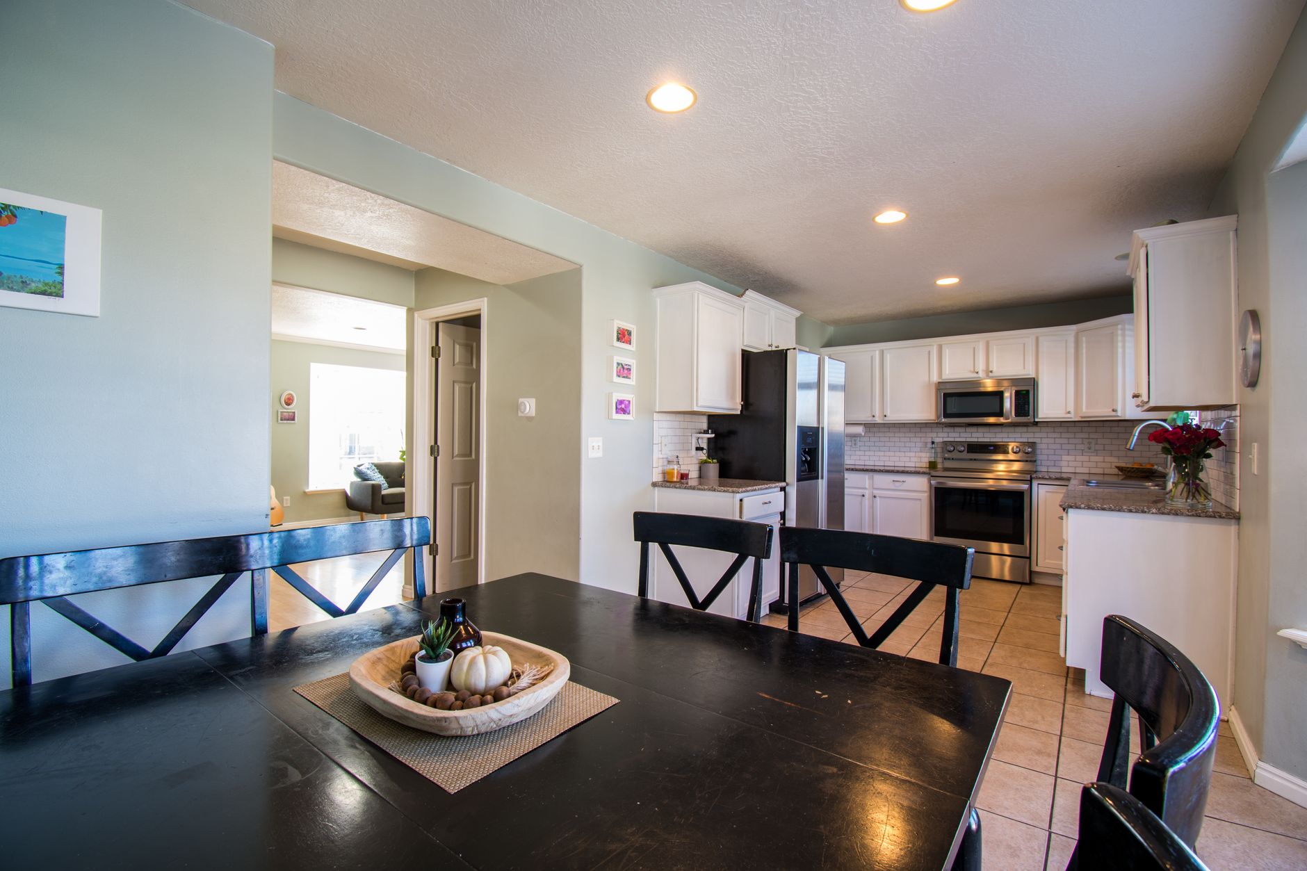 Spacious kitchen and dining area with modern design and elegant decor lighting.