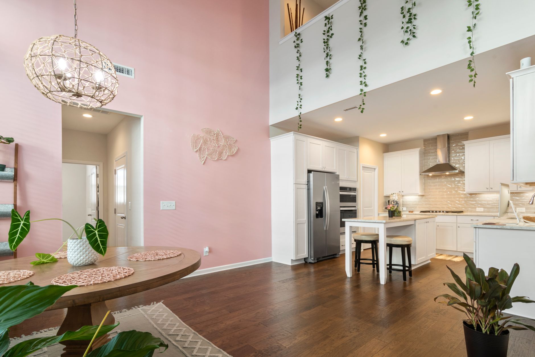 Bright and spacious open-plan kitchen with pink accents and modern decor.