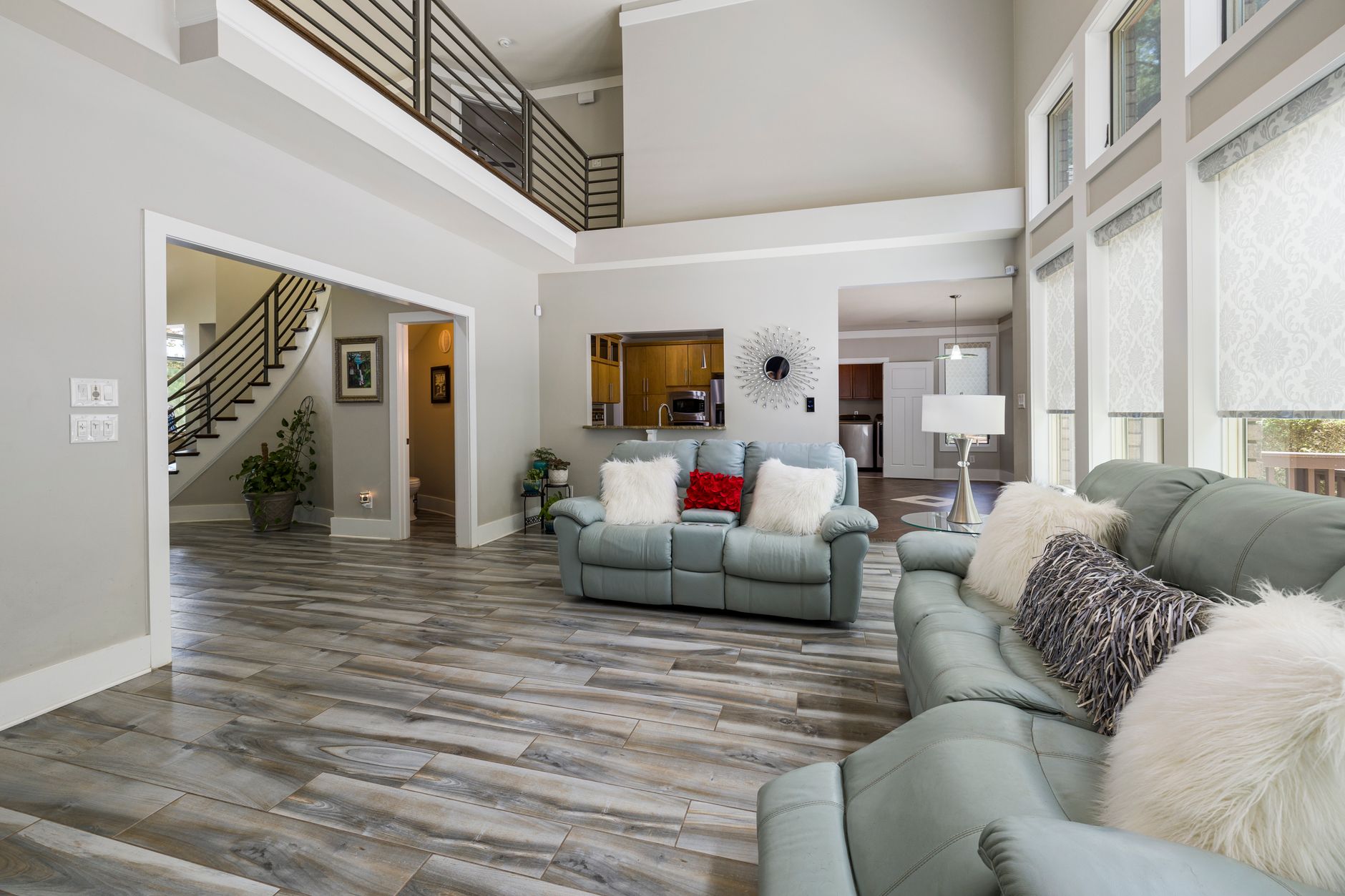 Spacious and stylish living room featuring contemporary decor, natural light, and a cozy ambiance.